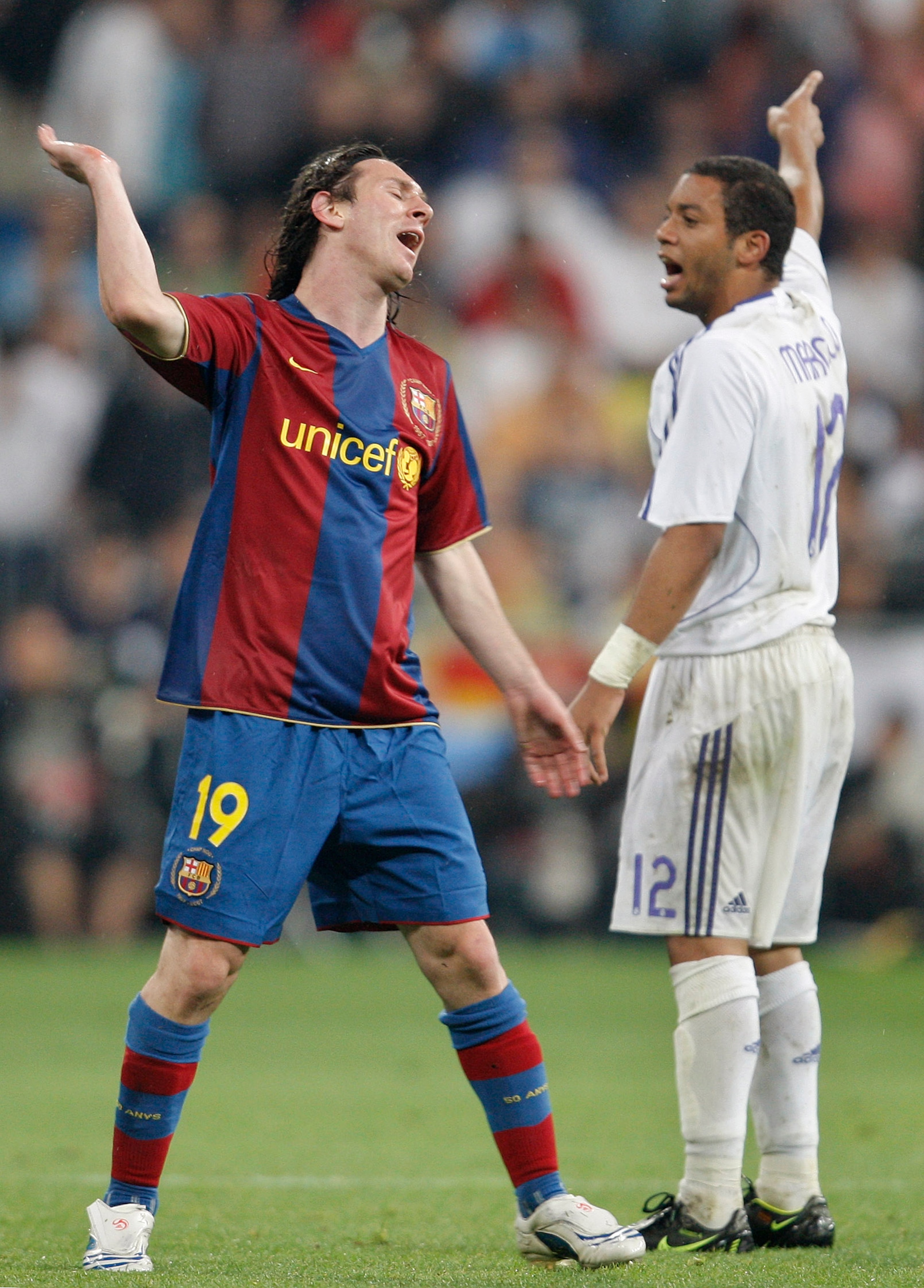 MADRID, SPAIN - MAY 07:  Lionel Messi (L) of Barcelona reacts flanked by Marcelo of Real Madrid during the La Liga match between Real Madrid and Barcelona at the Santiago Bernabeu Stadium on May 7, 2008 in Madrid, Spain. Barcelona lost the match 4-1.  (Ph