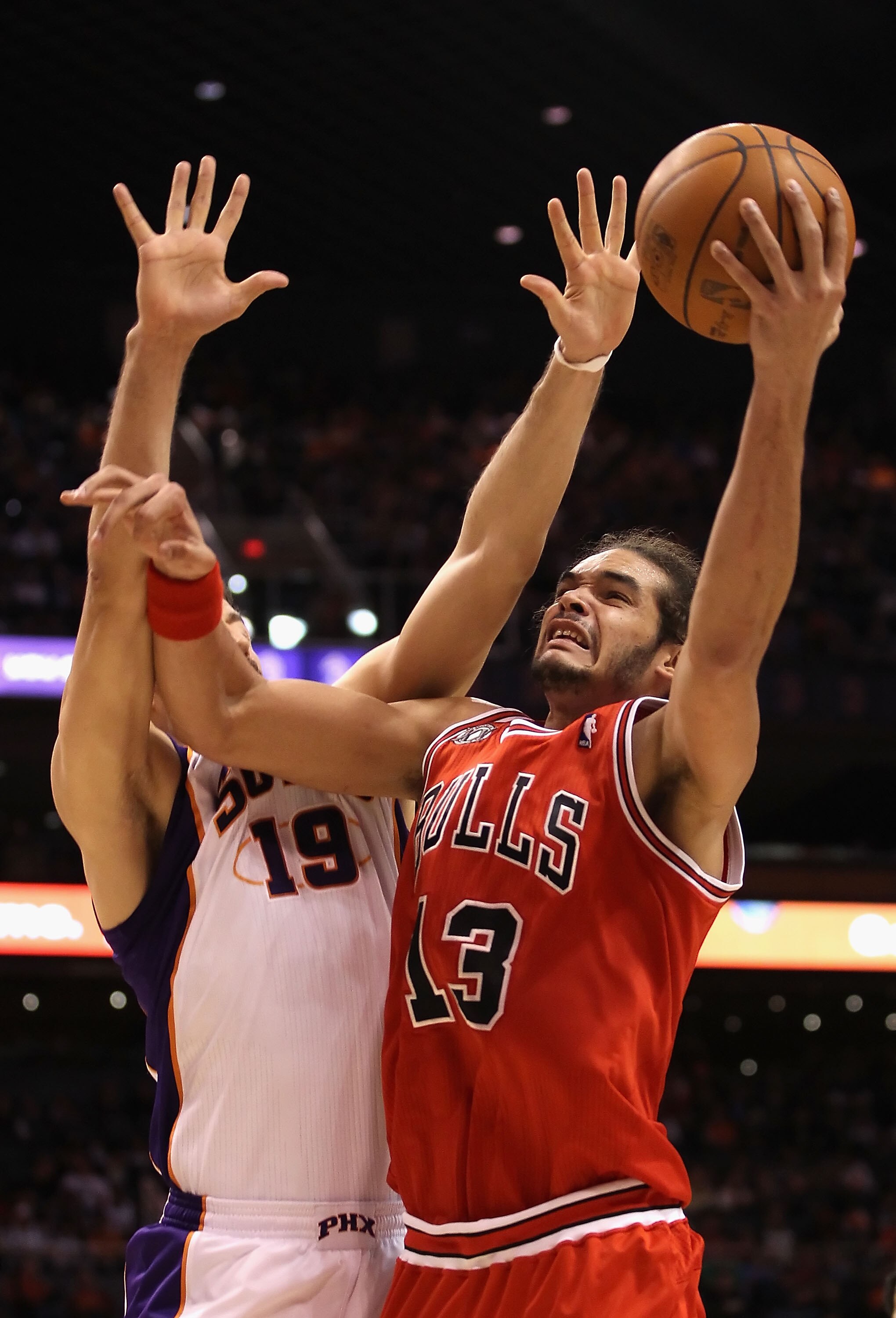 PHOENIX - NOVEMBER 24:  Joakim Noah #13 of the Chicago Bulls puts up a shot over Hedo Turkoglu #19 of the Phoenix Suns during the NBA game at US Airways Center on November 24, 2010 in Phoenix, Arizona. NOTE TO USER: User expressly acknowledges and agrees