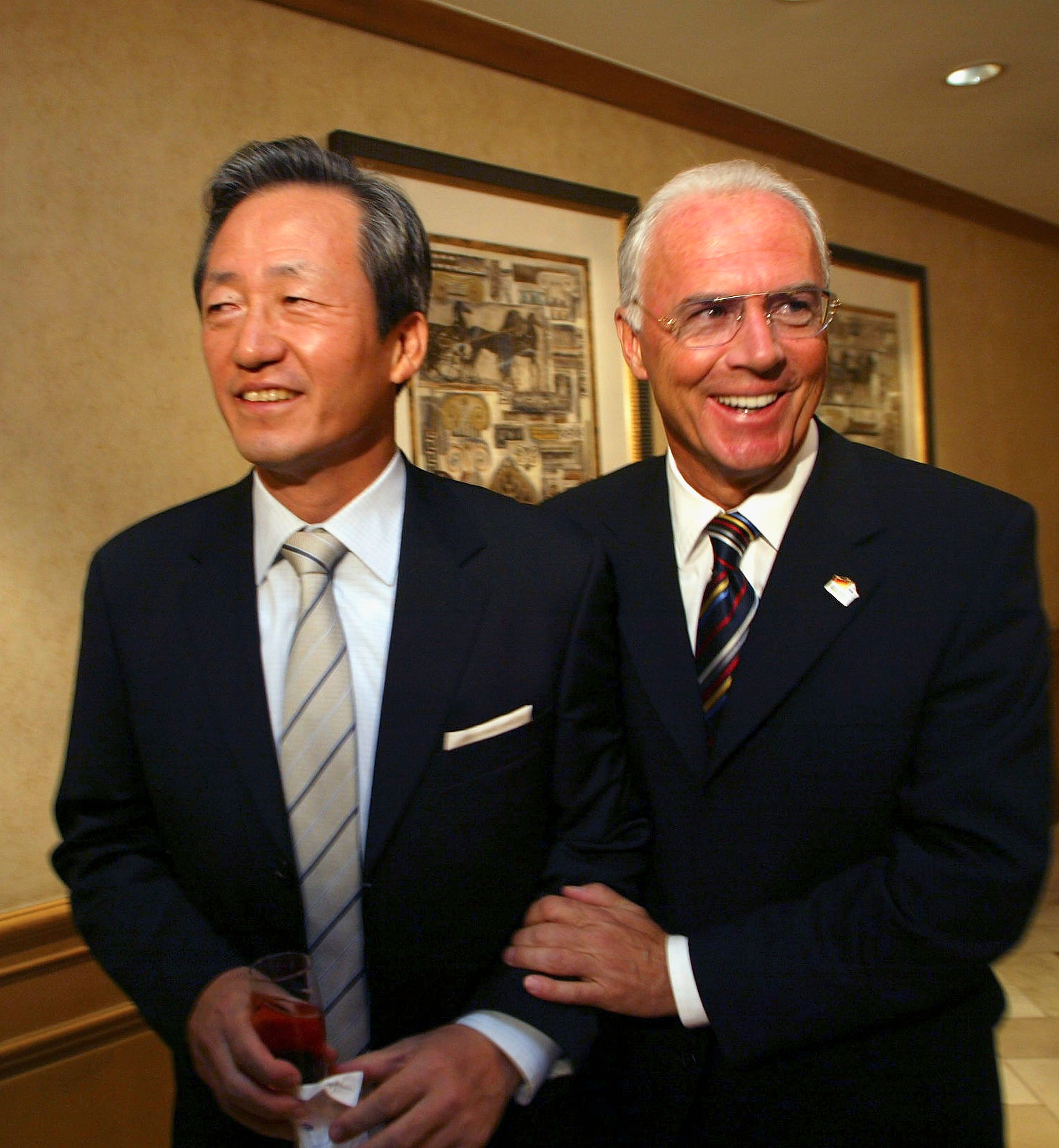 SEOUL, SOUTH KOREA - OCTOBER 5: Franz Beckenbauer (R), president of the 2006 Football World Cup organizing committee, jokes with Chung Mong-Joon, president of KFA (Korea Football Association) before a presentation session for 2006 Football World Cup on Oc SEOUL, SOUTH KOREA - OCTOBER 5: Franz Beckenbauer (R), president of the 2006 Football World Cup organizing committee, jokes with Chung Mong-Joon, president of KFA (Korea Football Association) before a presentation session for 2006 Football World Cup on Oc