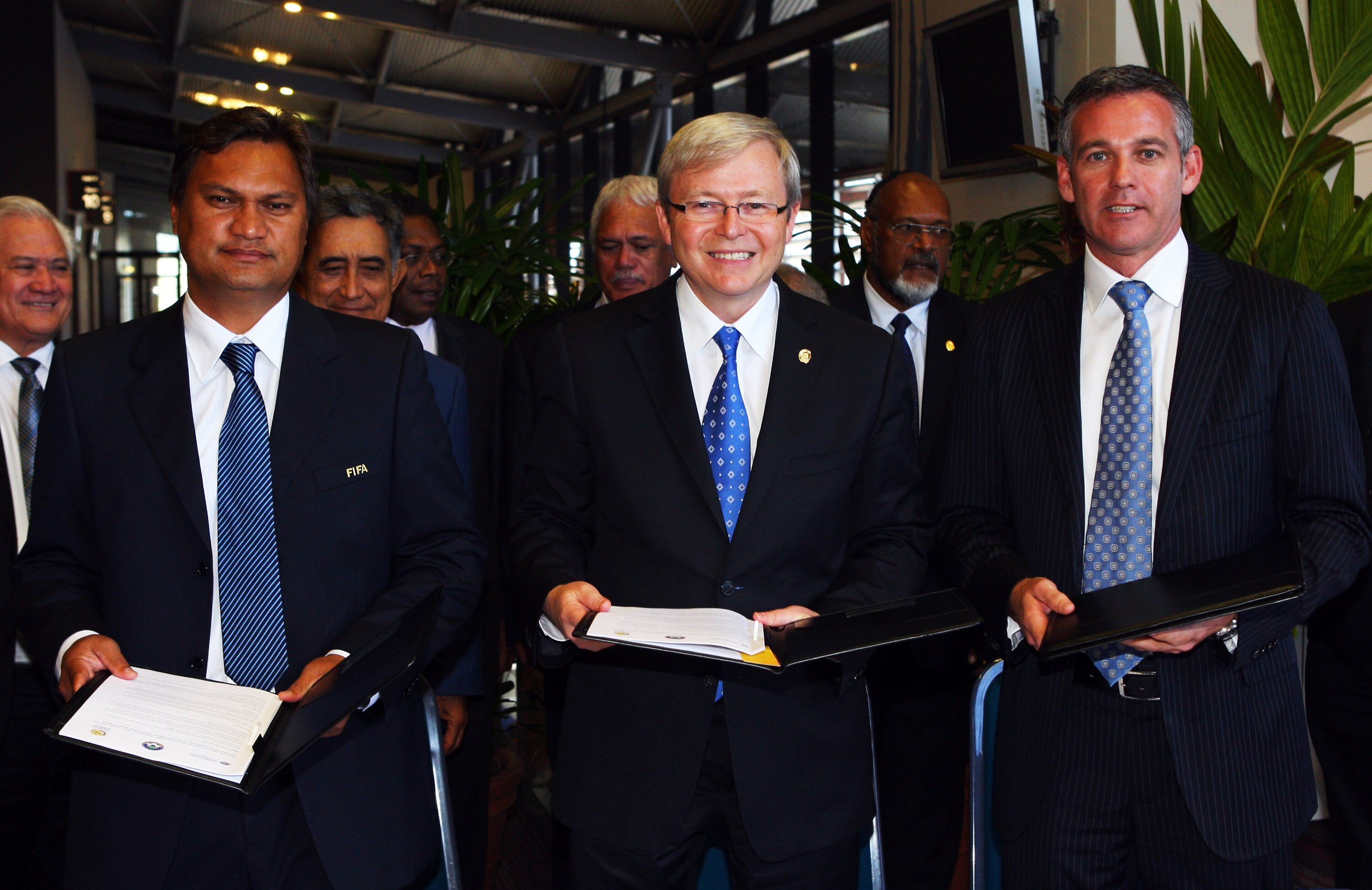 CAIRNS, AUSTRALIA - AUGUST 05:  (L-R) President of the Oceania Football Confederation Reynald Temarii, Australian Prime Minister Kevin Rudd and CEO of Football Australia Ben Buckley pose after signing an agreement at the Pacific Island Leaders Forum in th
