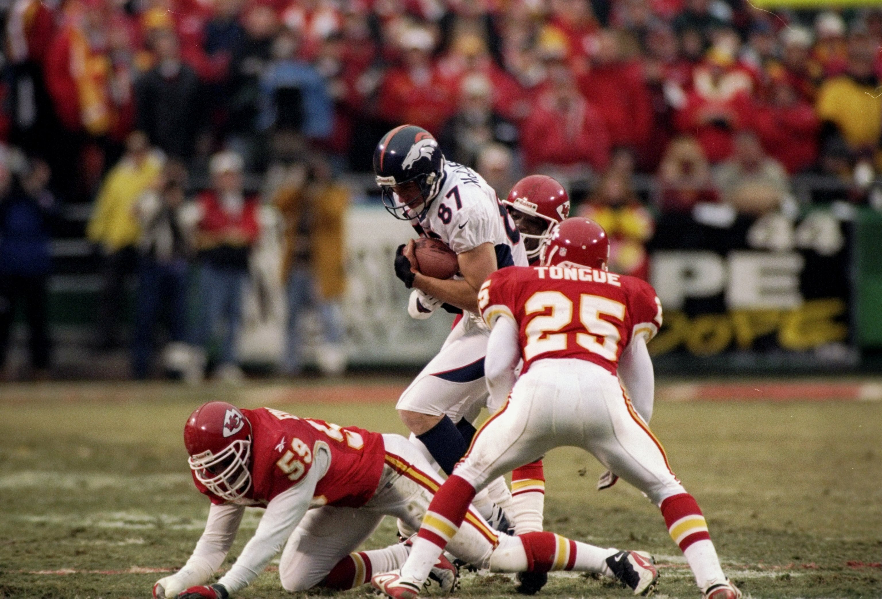 5 Jan 1998:  Tight end Ed McCaffery of the Denver Broncos tries to avoid linebacker Donnie Edwards of the Kansas City Chiefs during a playoff game at Arrowhead Stadium in Kansas City, Missouri.  The Broncos won the game 14-10. Mandatory Credit: Harry How