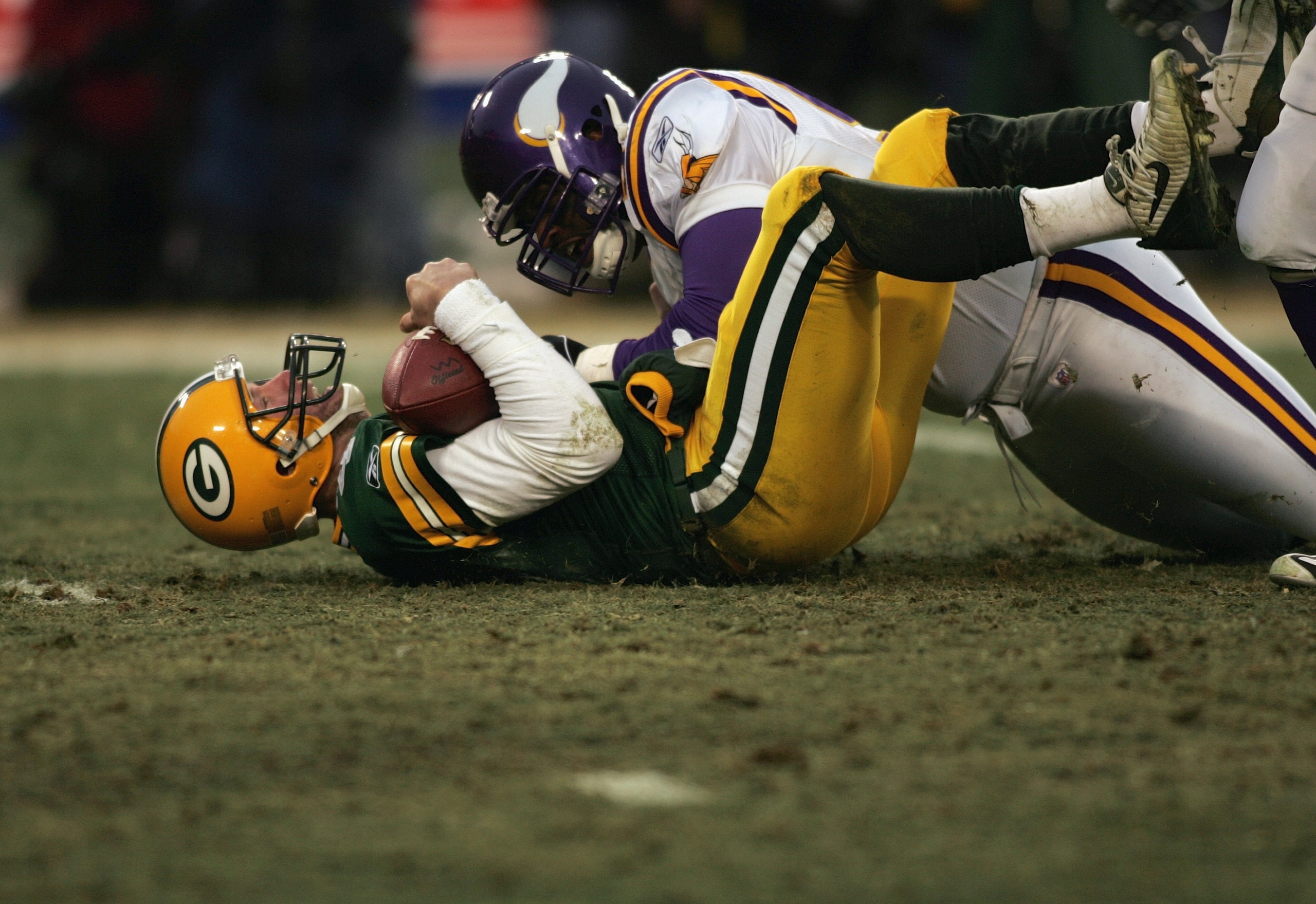GREEN BAY, WI - JANUARY 9:  Brett Favre #4 of the Green Bay Packers is tackled by a Minnesota Vikings defensive player during the game against the  in the NFC wild-card game at Lambeau Field on January 9, 2005 in Green Bay, Wisconsin. (Photo by Doug Benc/