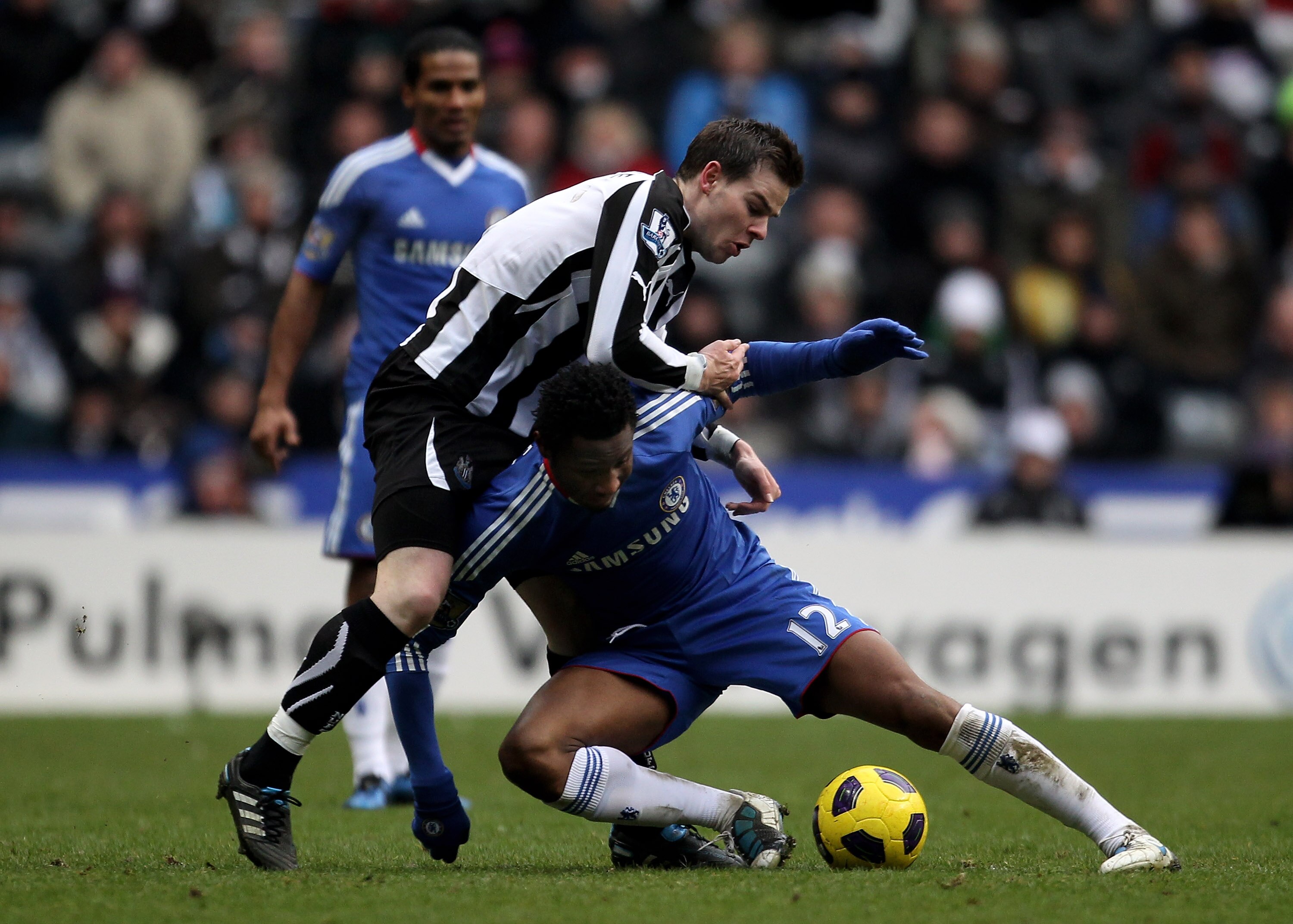 NEWCASTLE, UNITED KINGDOM - NOVEMBER 28:  John Obi Mikel of Chelsea tangles with Danny Guthrie of Newcastle United during the Barclays Premier League match between Newcastle United and Chelsea at St James' Park on November 28, 2010 in Newcastle, England. 