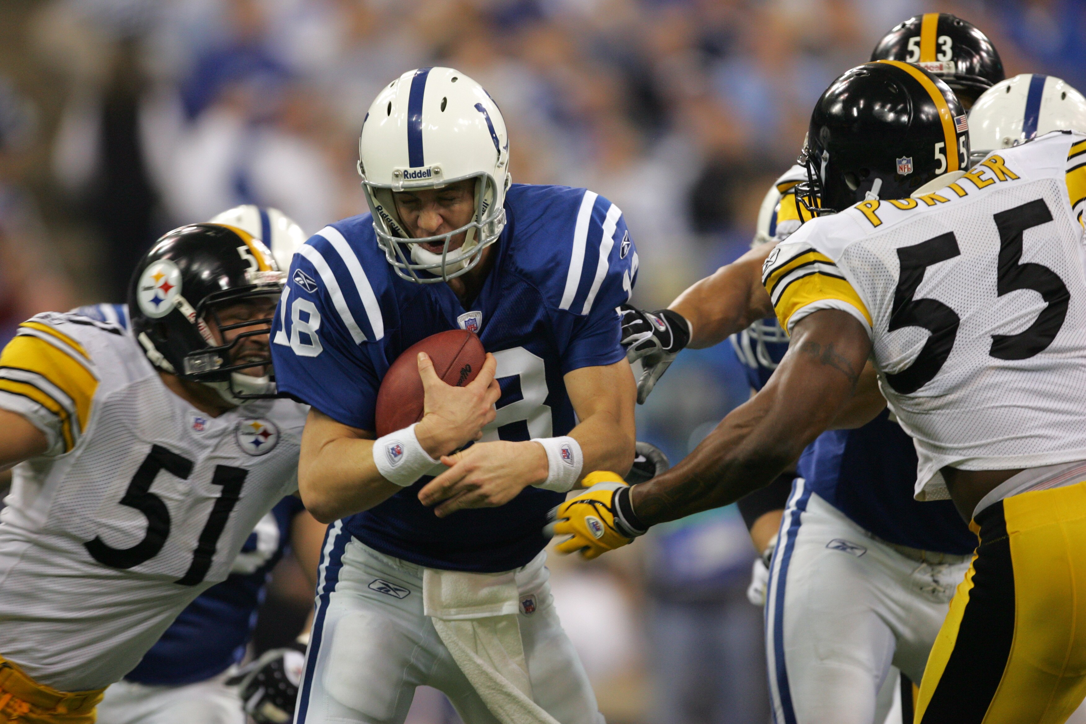 INDIANAPOLIS - JANUARY 15:  Peyton Manning #18 of Indianapolis Colts tries to elude the pass rush of James Farrior #51 and Joey Porter #55 of the Pittsburgh Steelers during the AFC Divisional Playoffs January 15, 2006 at the RCA Dome in Indianapolis, Indi
