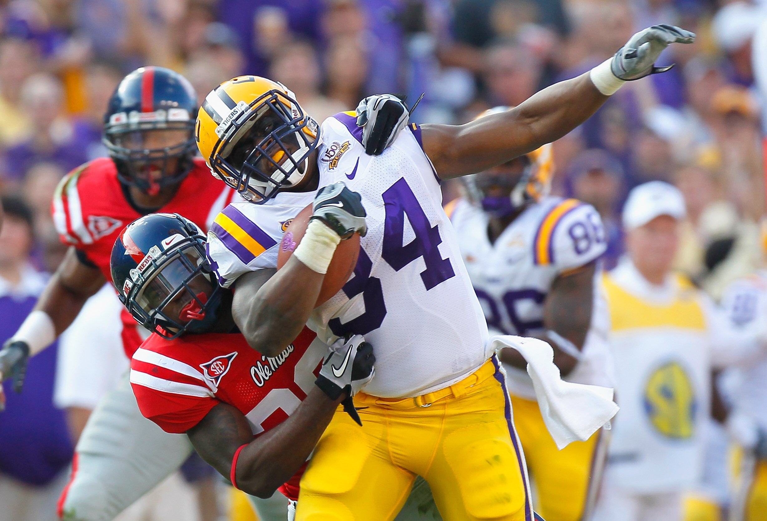 BATON ROUGE, LA - NOVEMBER 20:  Stevan Ridley #34 of the Louisiana State University Tigers is tackled by Johnny Brown #20 of the Ole Miss Rebels at Tiger Stadium on November 20, 2010 in Baton Rouge, Louisiana.  (Photo by Kevin C. Cox/Getty Images)