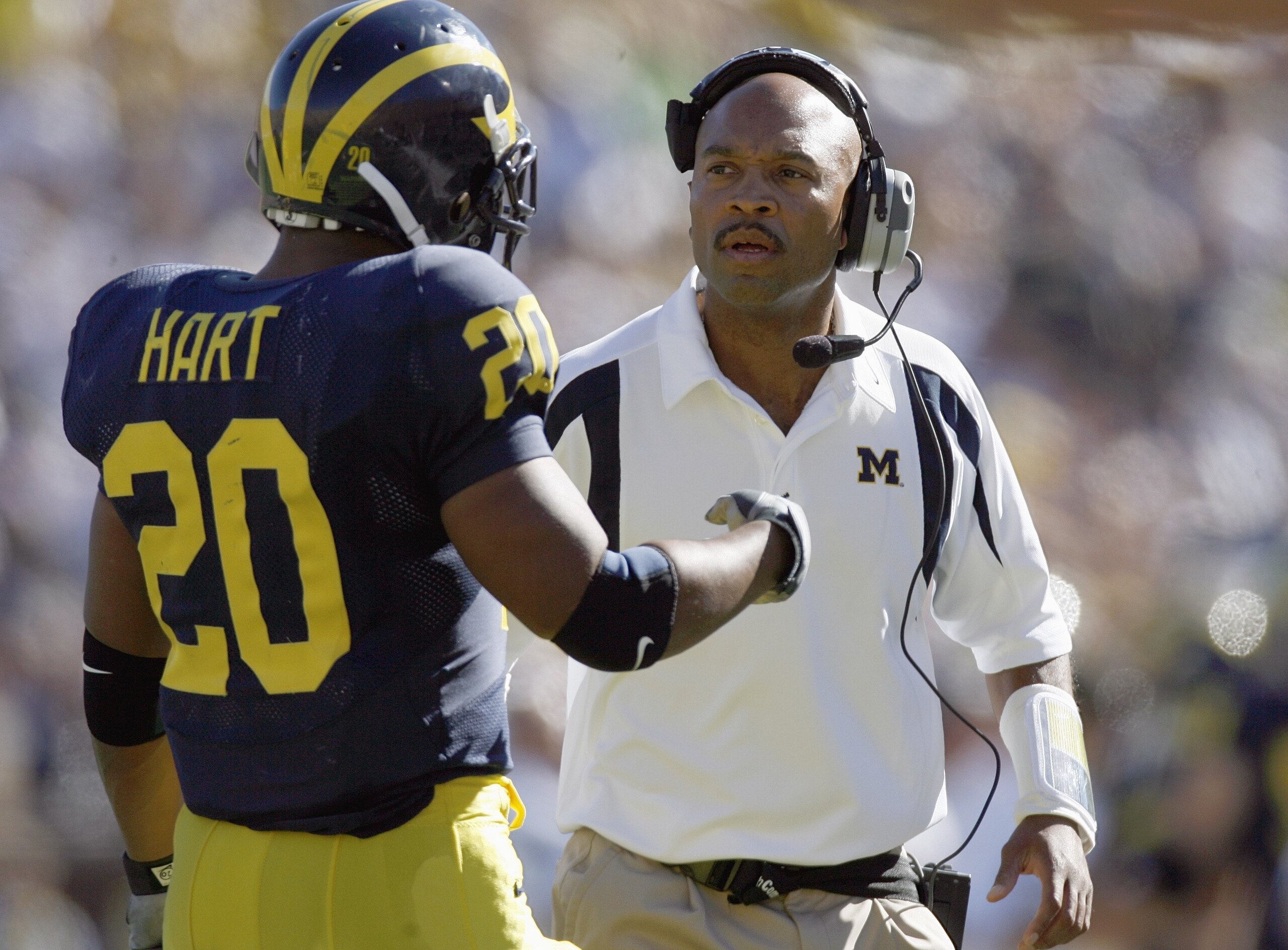ANN ARBOR, MI - SEPTEMBER 22: Mike Hart #20 of the Michigan Wolverines talks to assistant head coach Erik Campbell during the game against the Penn State Nittany Lions on September 22, 2007 at Michigan Stadium in Ann Arbor, Michigan. (Photo By Gregory Sha ANN ARBOR, MI - SEPTEMBER 22: Mike Hart #20 of the Michigan Wolverines talks to assistant head coach Erik Campbell during the game against the Penn State Nittany Lions on September 22, 2007 at Michigan Stadium in Ann Arbor, Michigan. (Photo By Gregory Sha