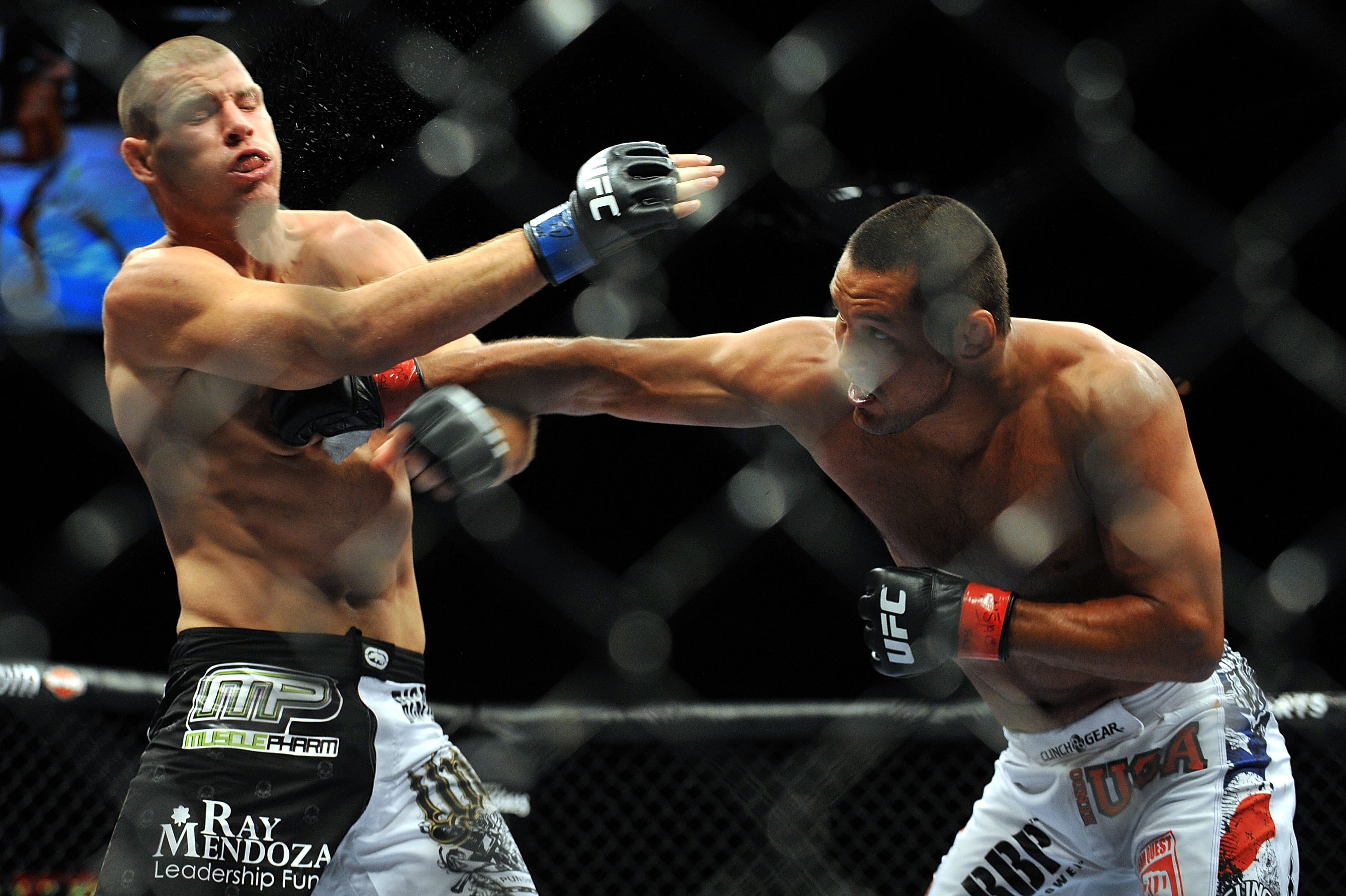 LAS VEGAS - JULY 11: (R-L) Dan Henderson connects with a right to Mike Bisping during their middleweight bout during UFC 100 on July 11, 2009 in Las Vegas, Nevada. (Photo by Jon Kopaloff/Getty Images) LAS VEGAS - JULY 11: (R-L) Dan Henderson connects with a right to Mike Bisping during their middleweight bout during UFC 100 on July 11, 2009 in Las Vegas, Nevada. (Photo by Jon Kopaloff/Getty Images)