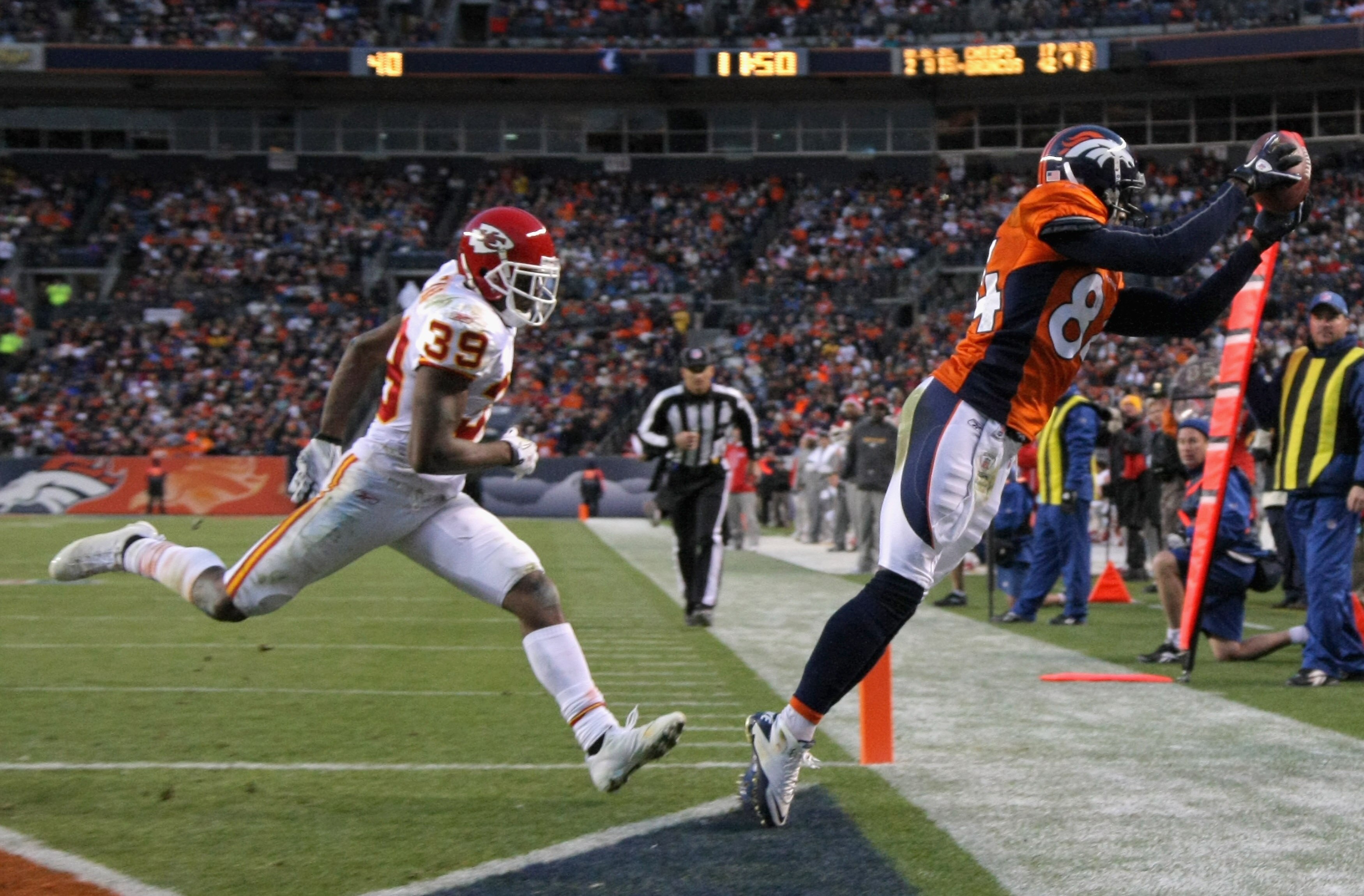 DENVER - NOVEMBER 14:  Wide receiver Brandon Lloyd #84 of the Denver Broncos makes a touchdown reception in fourth quarter as Brandon Carr #39 of the Kansas City Chiefs defends at INVESCO Field at Mile High on November 14, 2010 in Denver, Colorado. The pl