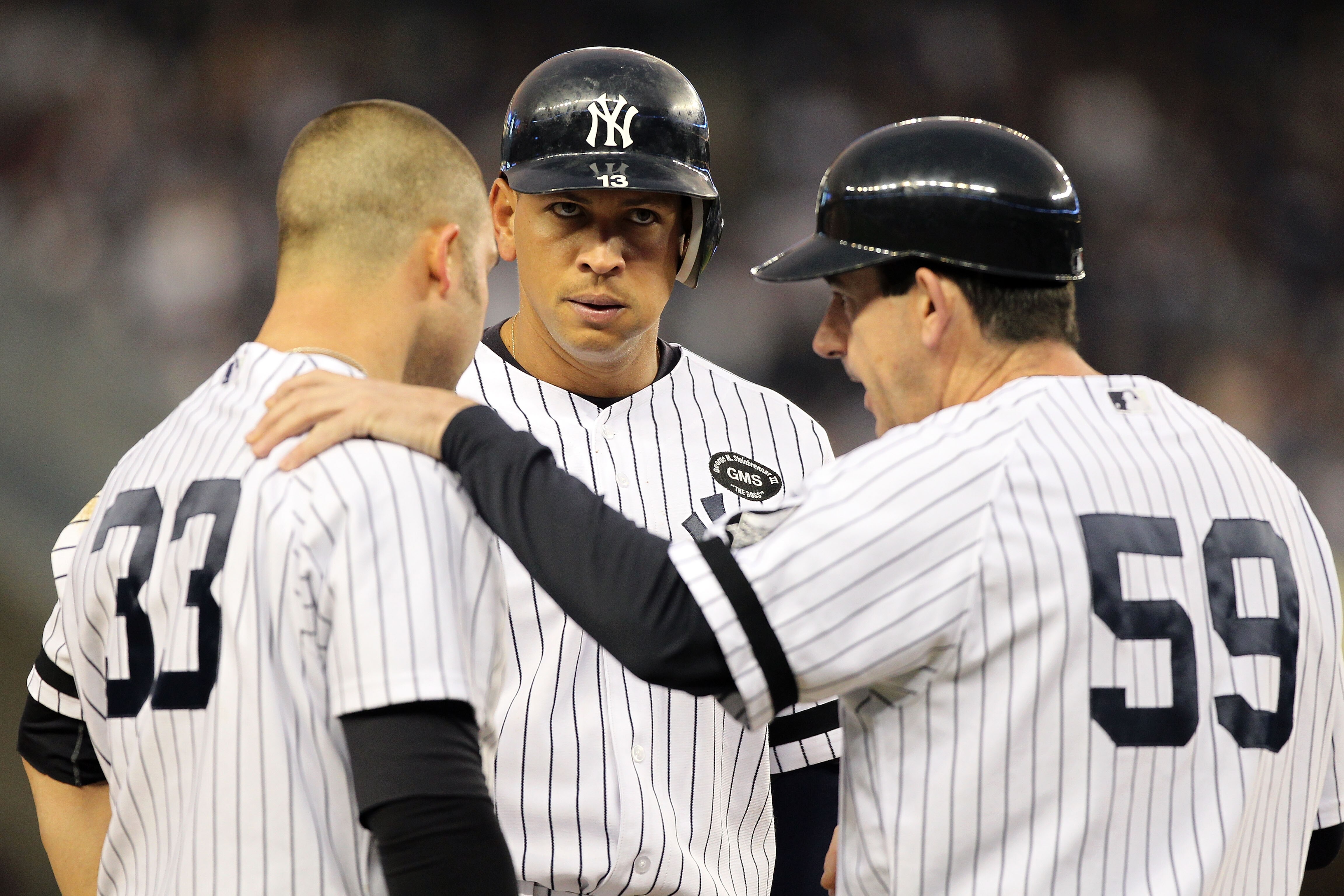 NEW YORK - OCTOBER 20:  (L-R) Nick Swisher #33, Alex Rodriguez #13 and third base coach Rob Thomson of the New York Yankees talk in the bottom of the fifth inning against the Texas Rangers in Game Five of the ALCS during the 2010 MLB Playoffs at Yankee St