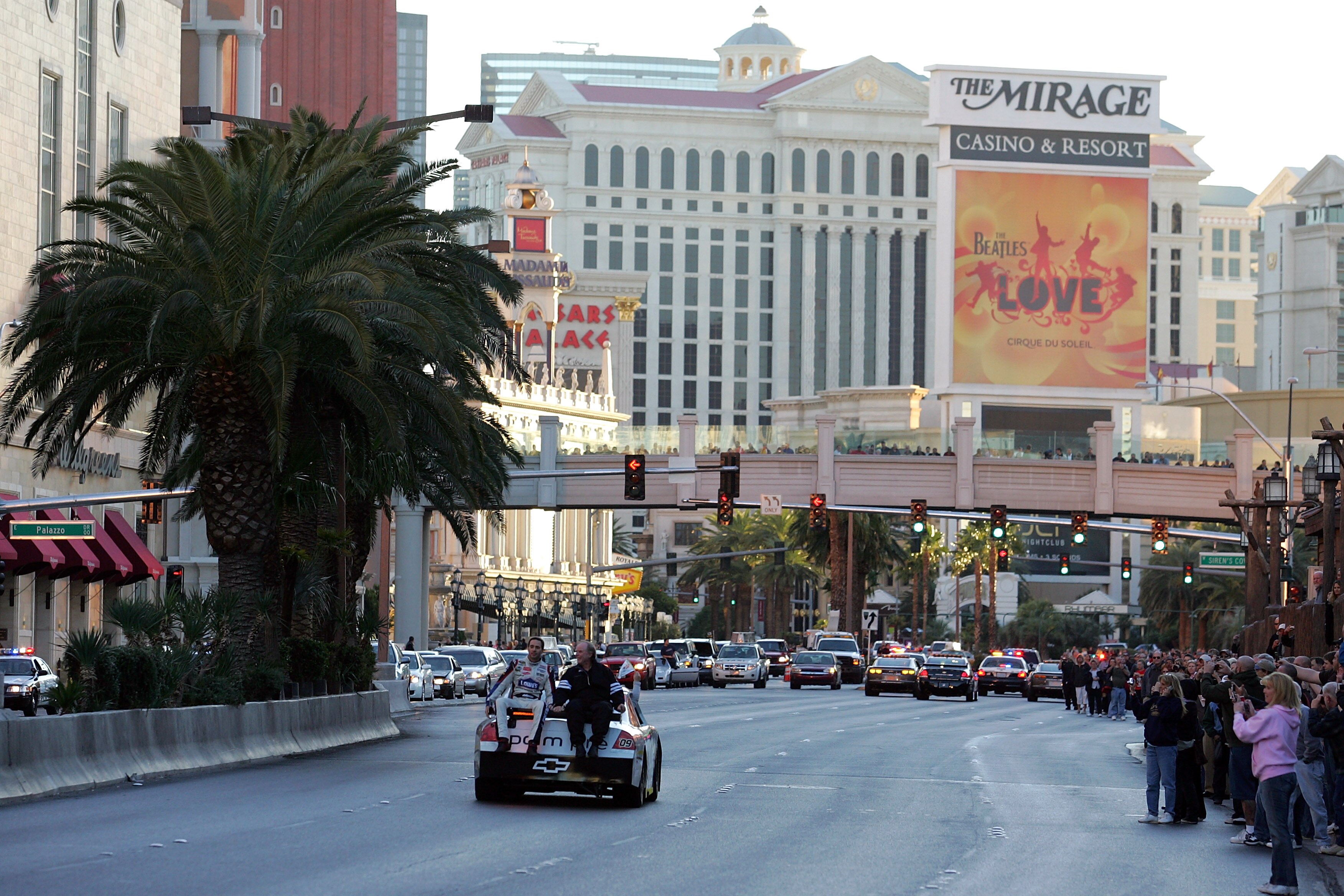 LAS VEGAS - DECEMBER 03:  Four time NASCAR Sprint Cup Champion Jimmie Johnson (L) rides with AP reporter Tim Dahlberg down Las Vegas Boulevard on the back of a sprint car after the Victory Lap of the NASCAR Sprint Cup Series Champions Week on December 3,
