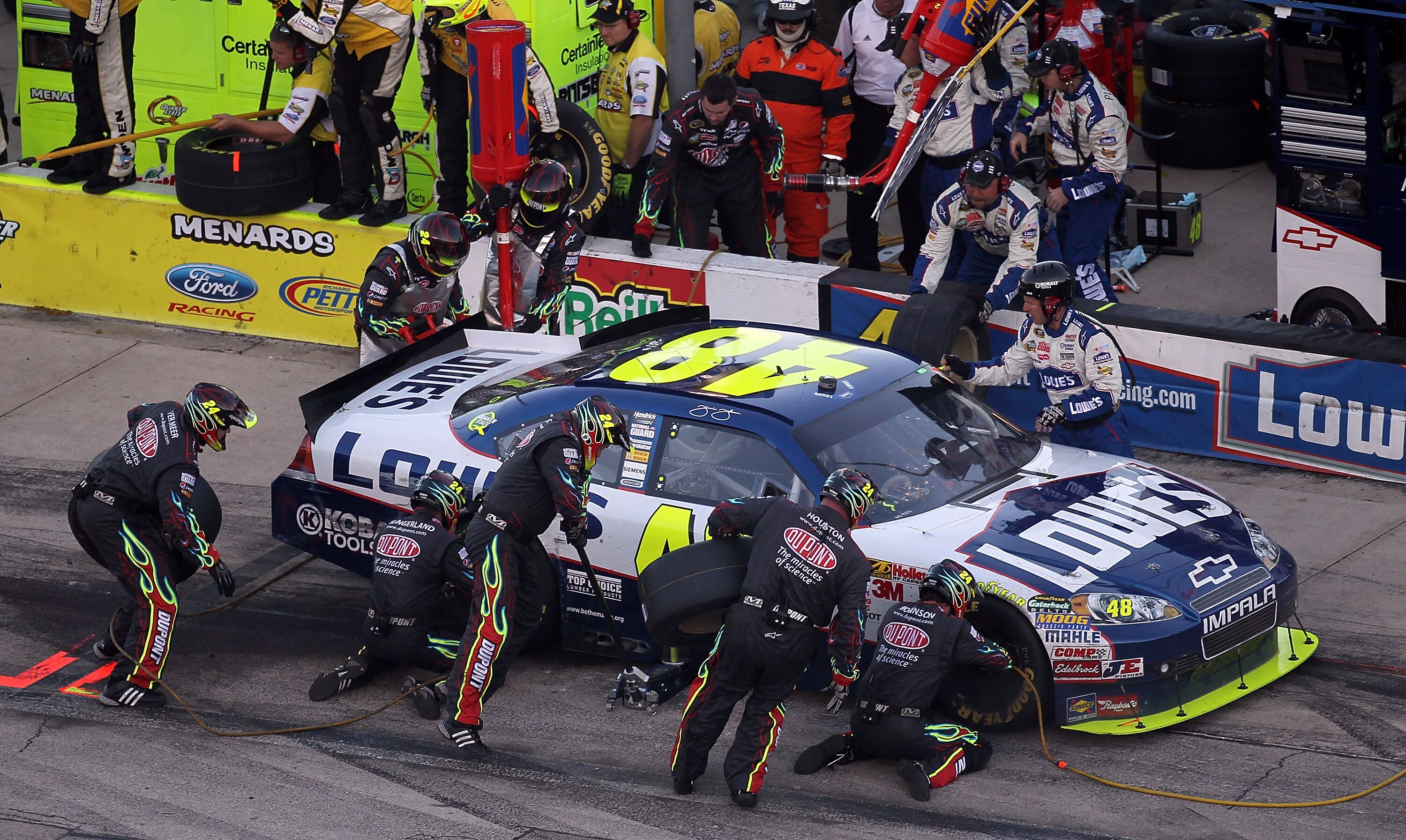 FORT WORTH, TX - NOVEMBER 07:  Jimmie Johnson, driver of the #48 Lowe's Chevrolet,  makes a pit stop during the NASCAR Sprint Cup Series AAA Texas 500 at Texas Motor Speedway on November 7, 2010 in Fort Worth, Texas.  (Photo by Jonathan Ferrey/Getty Image