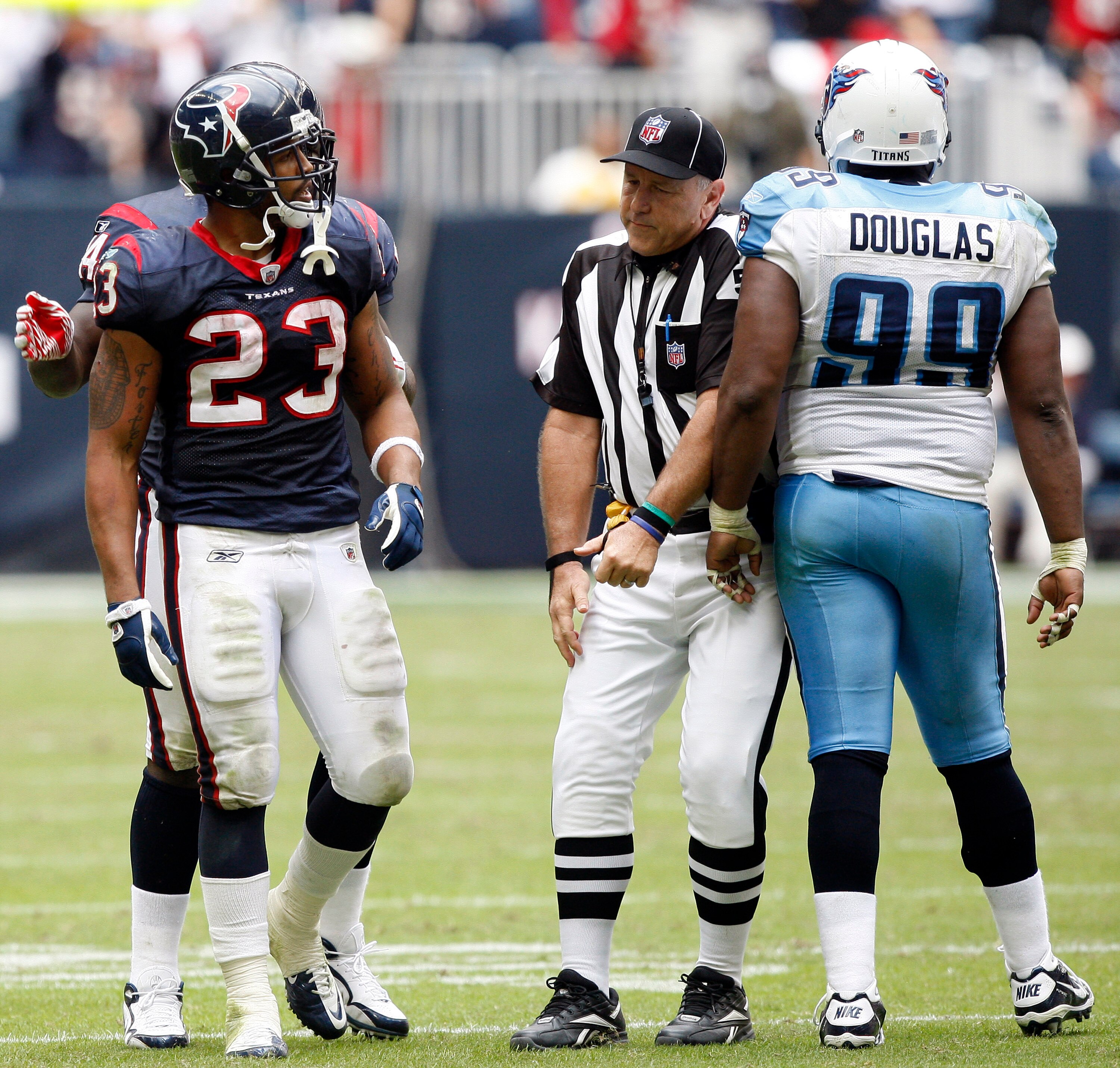 HOUSTON - NOVEMBER 28:  Running back Arian Foster #23 of the Houston Texans has words with defensive tackle Marques Douglas #99 of the Tennessee Titans at Reliant Stadium on November 28, 2010 in Houston, Texas.  (Photo by Bob Levey/Getty Images)