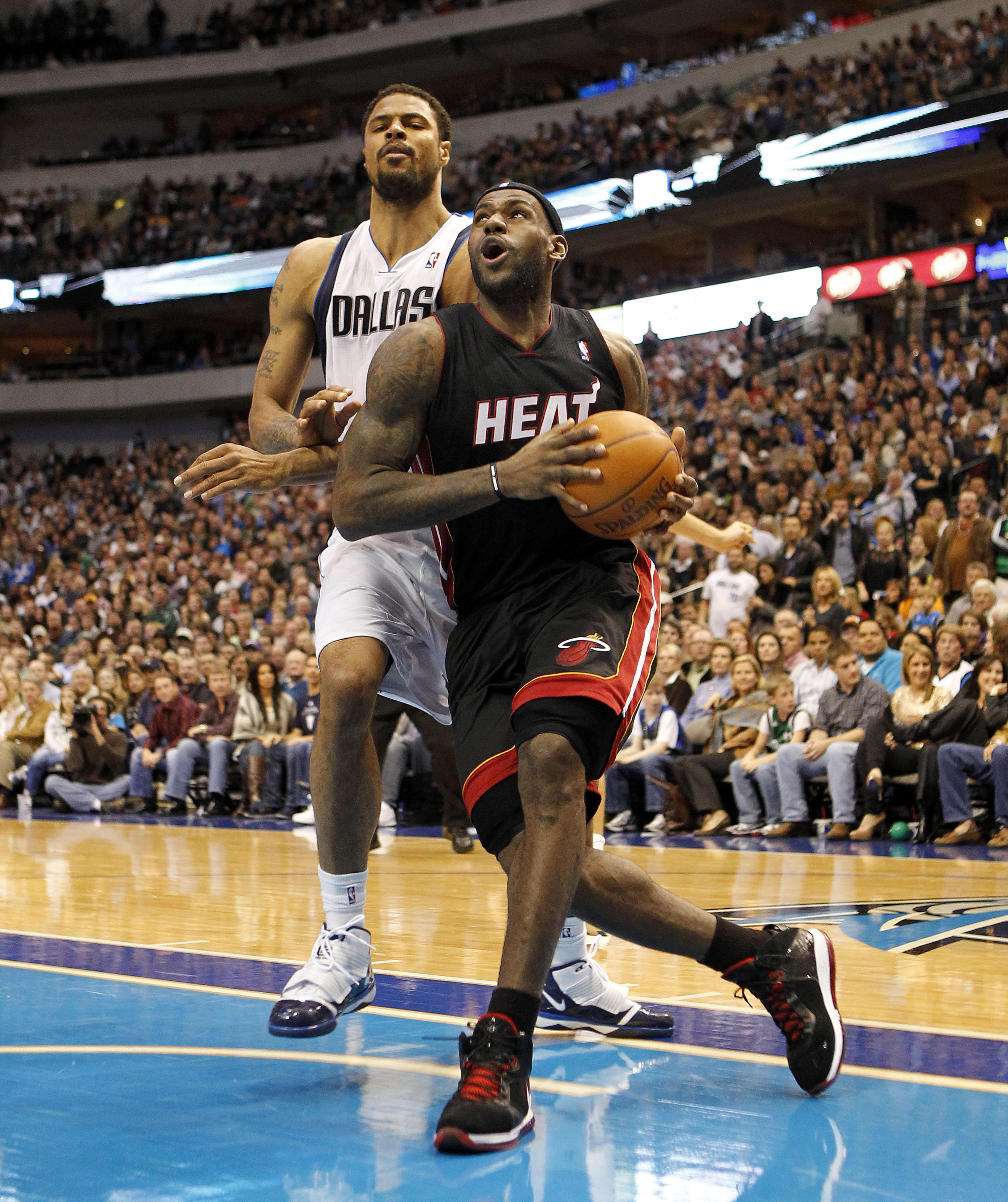DALLAS - NOVEMBER 27: LeBron James #6 of the Miami Heat drives by Tyson Chandler #6 of the Dallas Mavericks on November 27, 2010 at the American Airlines Center in Dallas, Texas. NOTE TO USER: User expressly acknowledges and agrees that, by downloading an