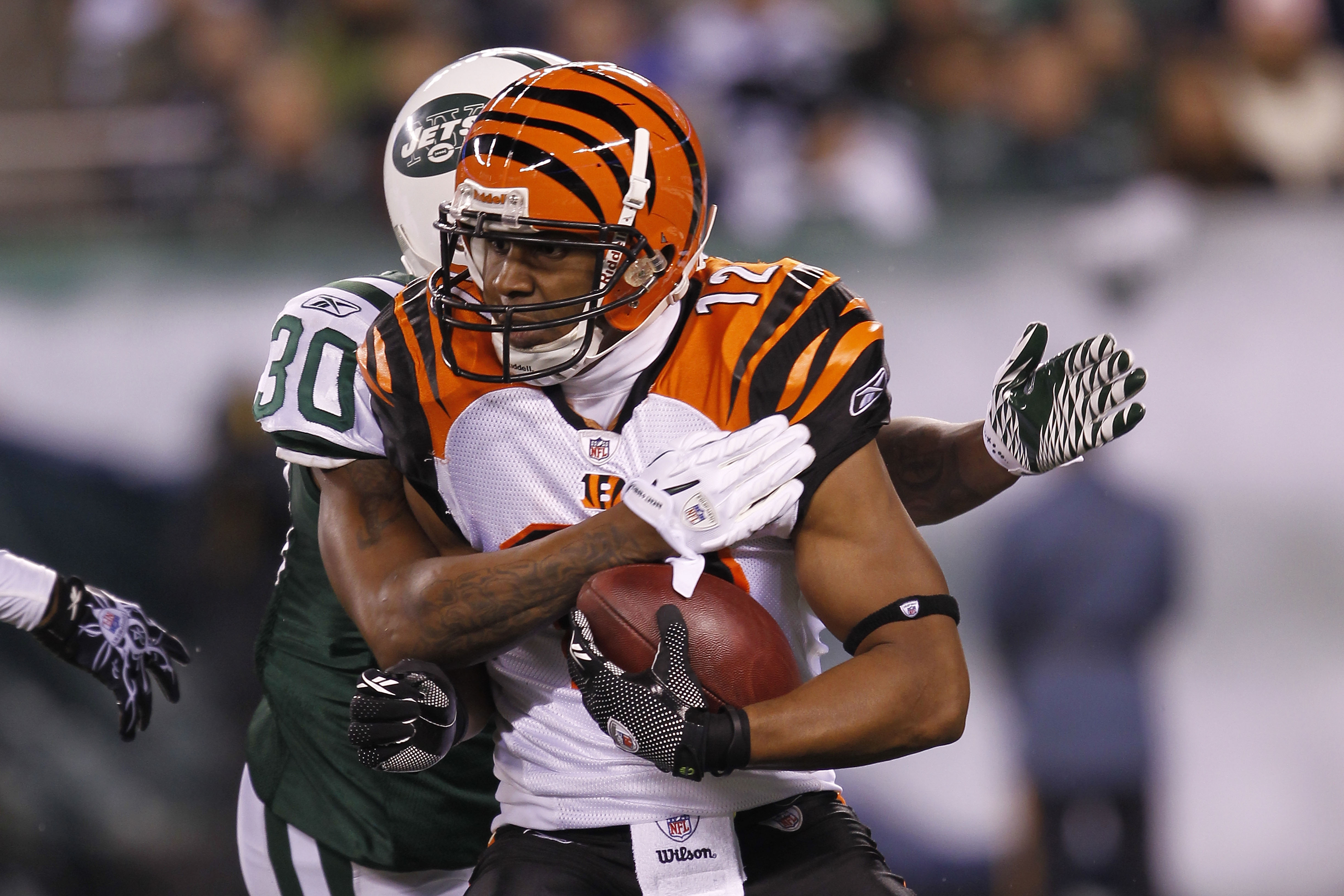 EAST RUTHERFORD, NJ - NOVEMBER 25: Quan Cosby #12 of the Cincinnati Bengals is tackled by Drew Coleman #30 of the New York Giants at New Meadowlands Stadium on November 25, 2010 in East Rutherford, New Jersey.  (Photo by Chris Trotman/Getty Images)