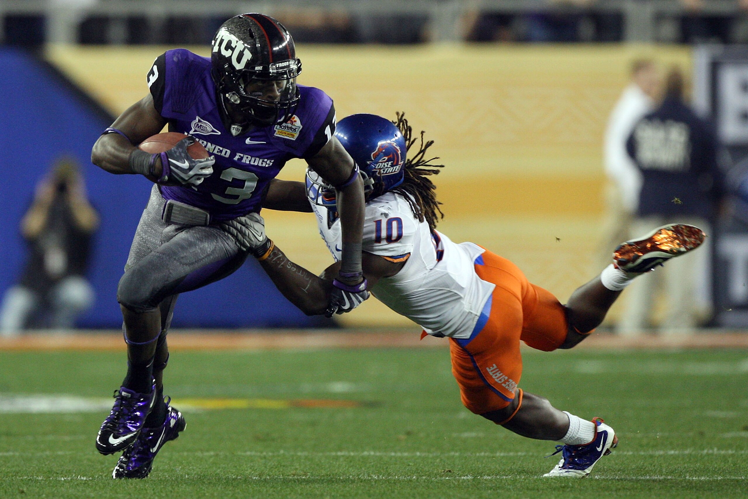 GLENDALE, AZ - JANUARY 04: Antoine Hicks #13 of the TCU Horned Frogs runs after a catch as he is grabbed by Jerrell Gavins #10 of the Boise State Broncos during the Tostitos Fiesta Bowl at the Universtity of Phoenix Stadium on January 4, 2010 in Glendale GLENDALE, AZ - JANUARY 04: Antoine Hicks #13 of the TCU Horned Frogs runs after a catch as he is grabbed by Jerrell Gavins #10 of the Boise State Broncos during the Tostitos Fiesta Bowl at the Universtity of Phoenix Stadium on January 4, 2010 in Glendale