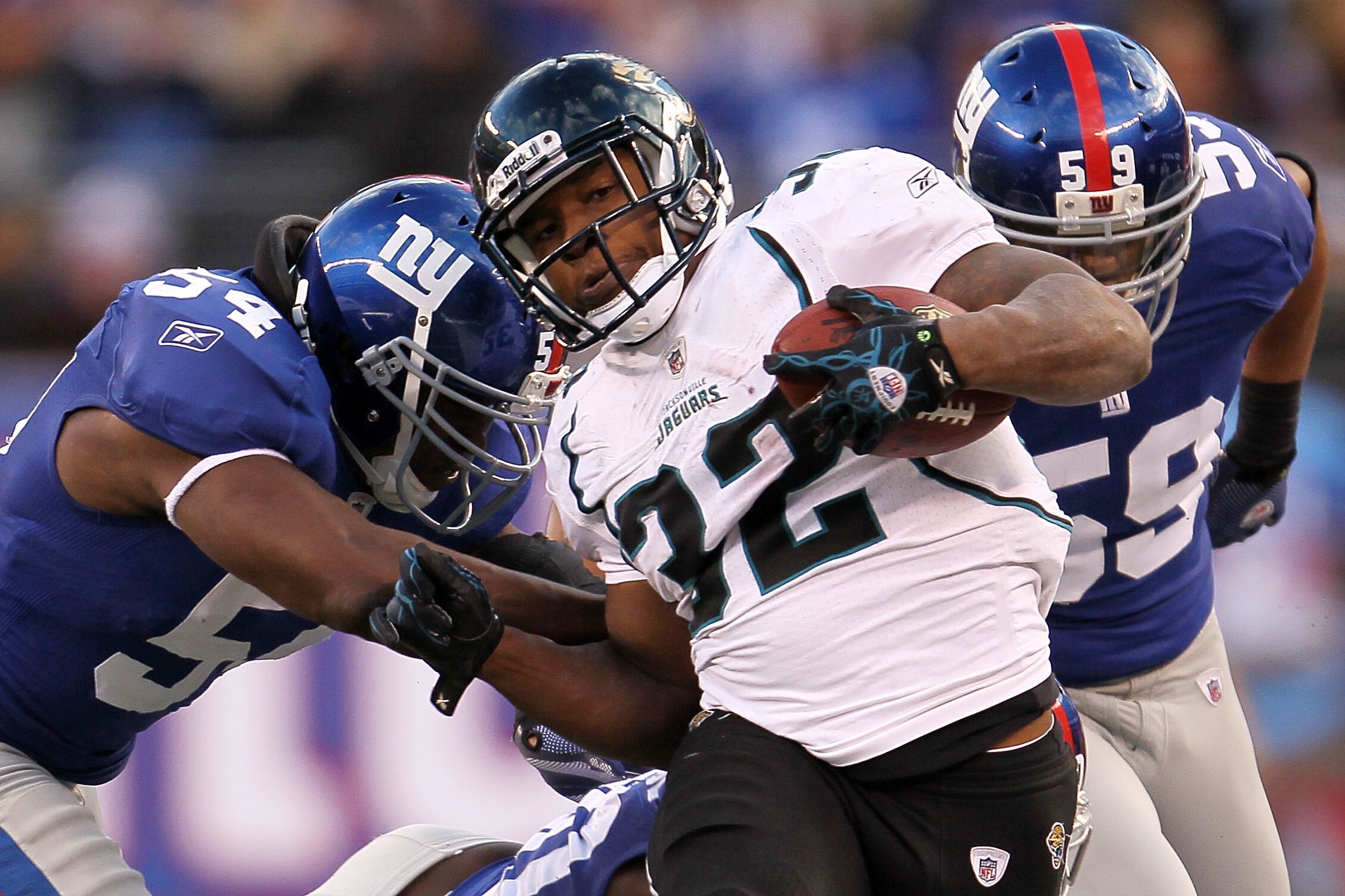 EAST RUTHERFORD, NJ - NOVEMBER 28: Maurice Jones-Drew of the Jacksonville Jaguars is tackled by Jonathan Goff #54 of the New York Giants at New Meadowlands Stadium on November 28, 2010 in East Rutherford, New Jersey.  (Photo by Chris McGrath/Getty Images)