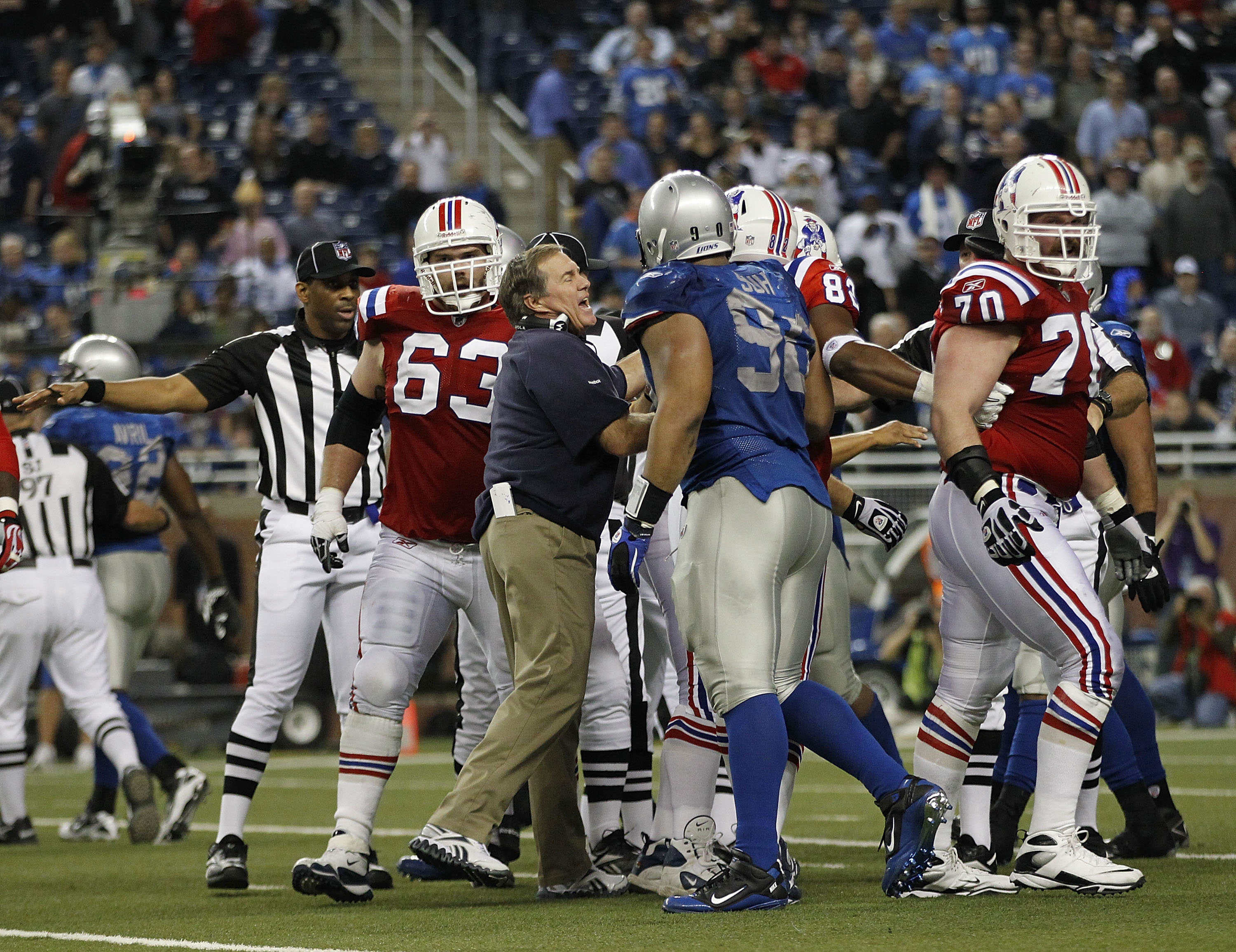 DETROIT - NOVEMBER 25:  New England Patriots head coach Bill Belichick breaks up a late fourth quarter scuffle between the Lions and the Patriots during the game at Ford Field on November 25, 2010 in Detroit, Michigan. New England defeated Detroit 45-24.