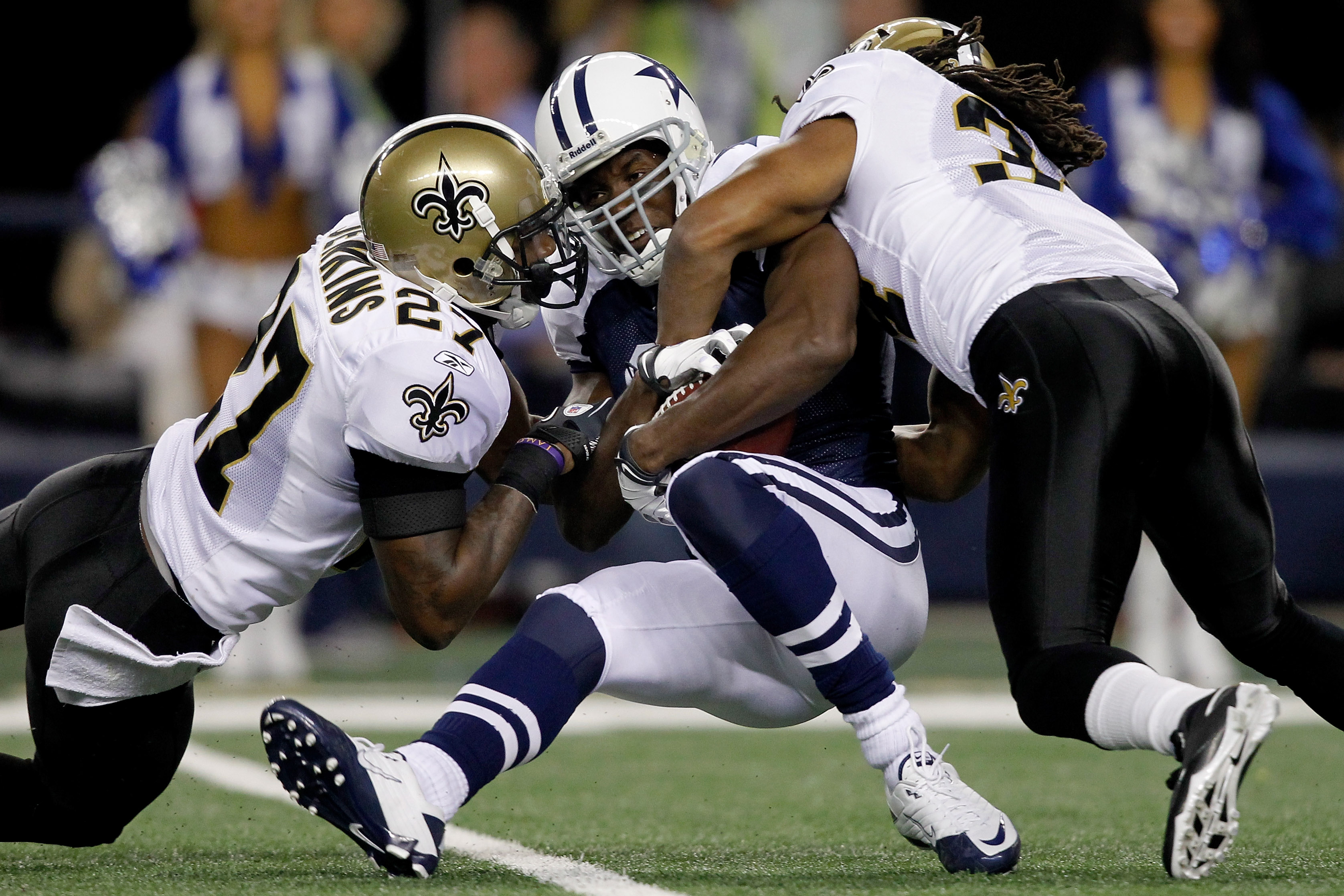 ARLINGTON, TX - NOVEMBER 25:  Tracy Porter #22 and Jonathan Vilma #51 of the New Orleans Saints tackle Jason Whitten #82 of the Dallas Cowboys at Cowboys Stadium on November 25, 2010 in Arlington, Texas.  (Photo by Matthew Stockman/Getty Images)