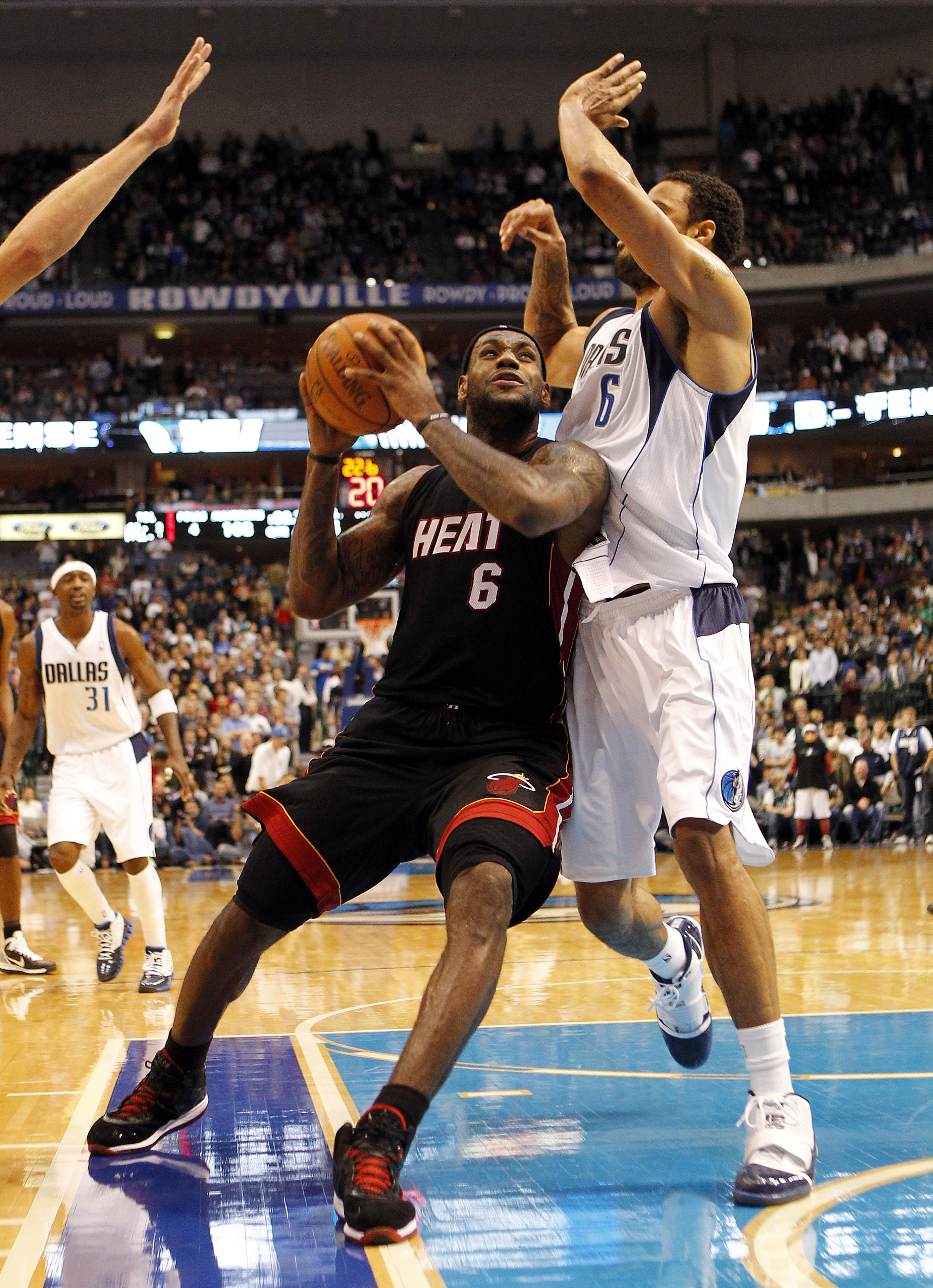 DALLAS - NOVEMBER 27: LeBron James #6 of the Miami Heat drives by Tyson Chandler #6 of the Dallas Mavericks on November 27, 2010 at the American Airlines Center in Dallas, Texas. NOTE TO USER: User expressly acknowledges and agrees that, by downloading an