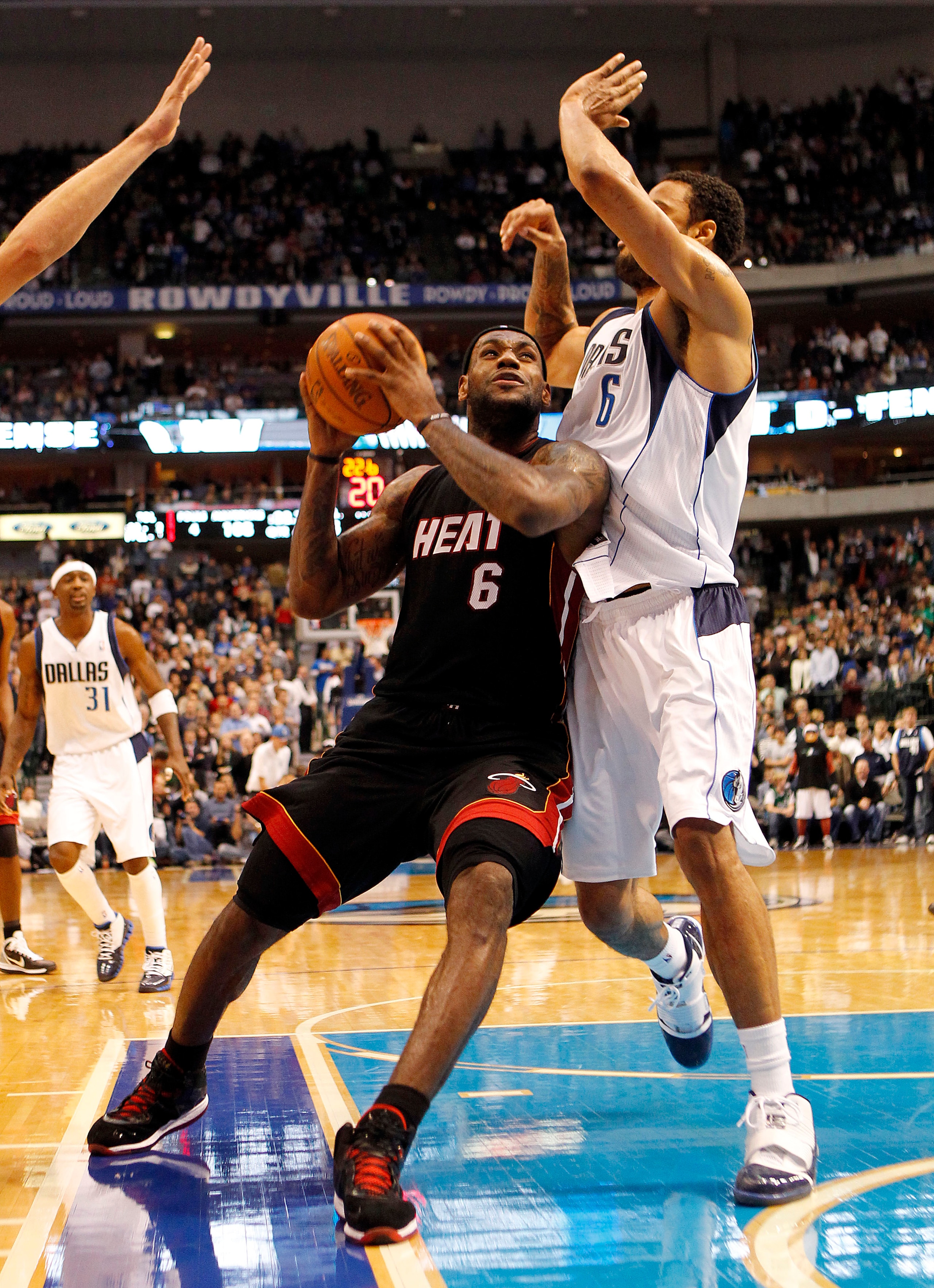DALLAS - NOVEMBER 27: LeBron James #6 of the Miami Heat drives by Tyson Chandler #6 of the Dallas Mavericks on November 27, 2010 at the American Airlines Center in Dallas, Texas. NOTE TO USER: User expressly acknowledges and agrees that, by downloading an