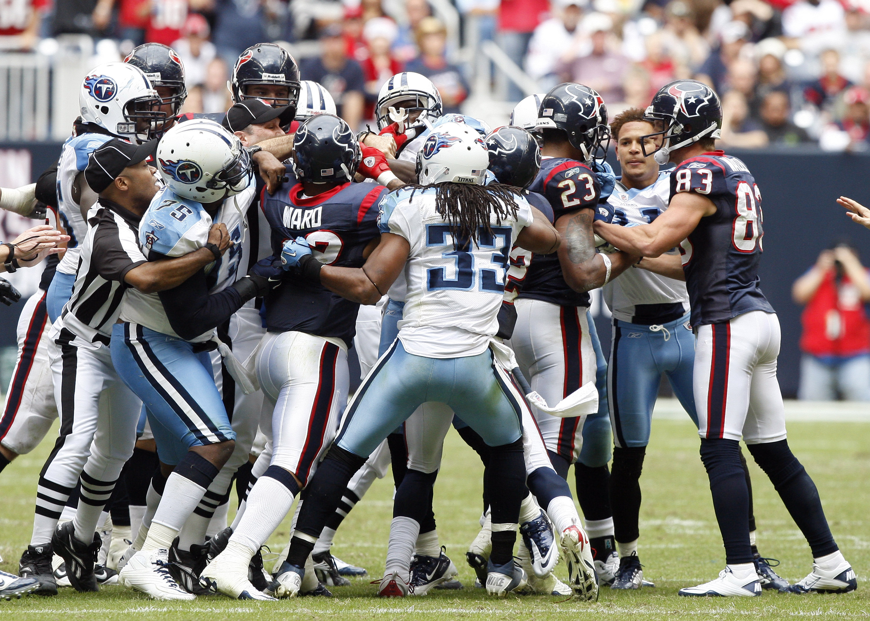HOUSTON - NOVEMBER 28:  Officials attempt to separate players from both the Houston Texans and Tennessee Titans after a bench emptying brawl in the fourth quarter that was started by Andre Johnson of the Houston Texans and Cortland Finnegan of the Tenness