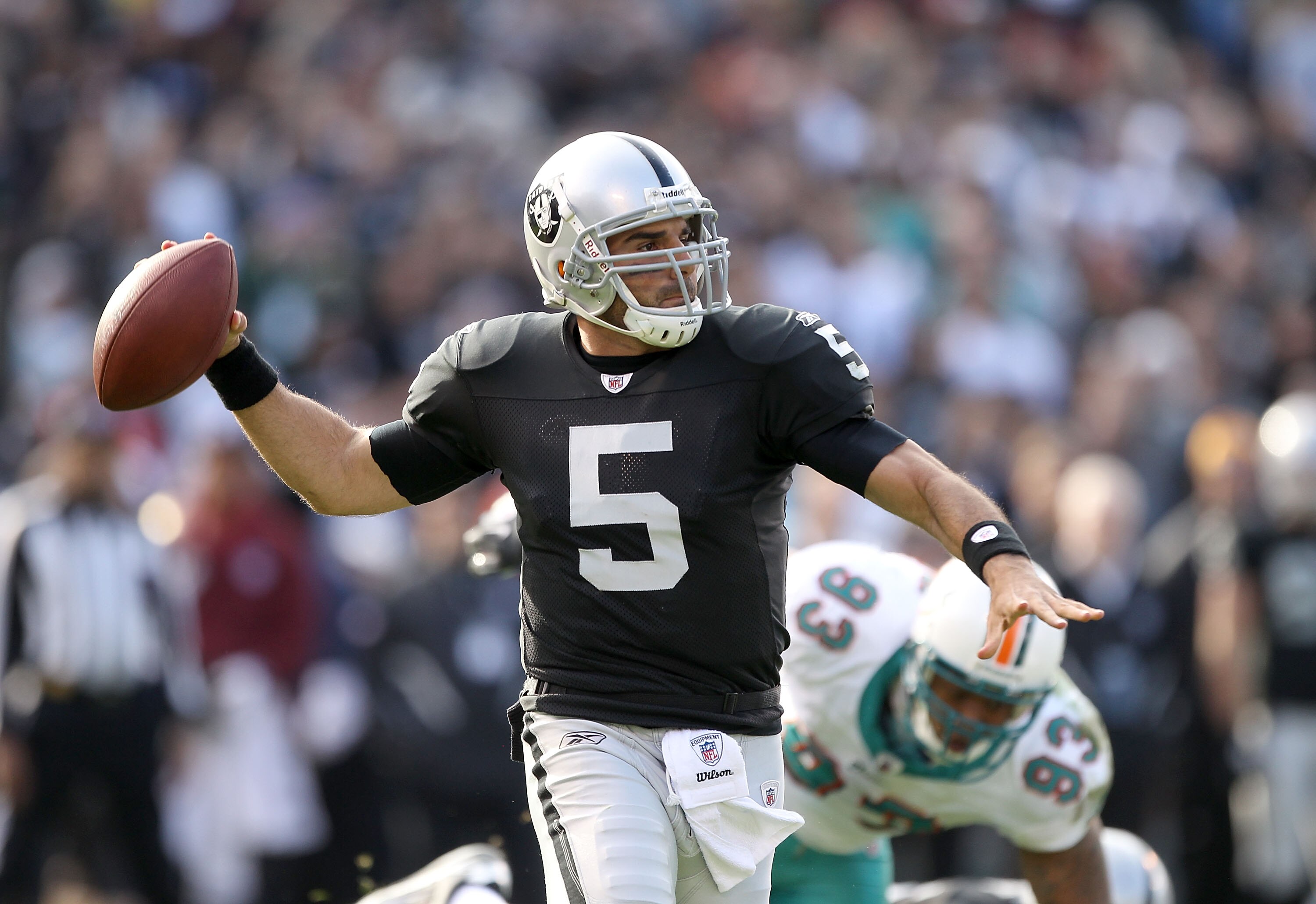 OAKLAND, CA - NOVEMBER 28:  Bruce Gradkowski #5 of the Oakland Raiders passes the ball against the Miami Dolphins at Oakland-Alameda County Coliseum on November 28, 2010 in Oakland, California.  (Photo by Ezra Shaw/Getty Images)