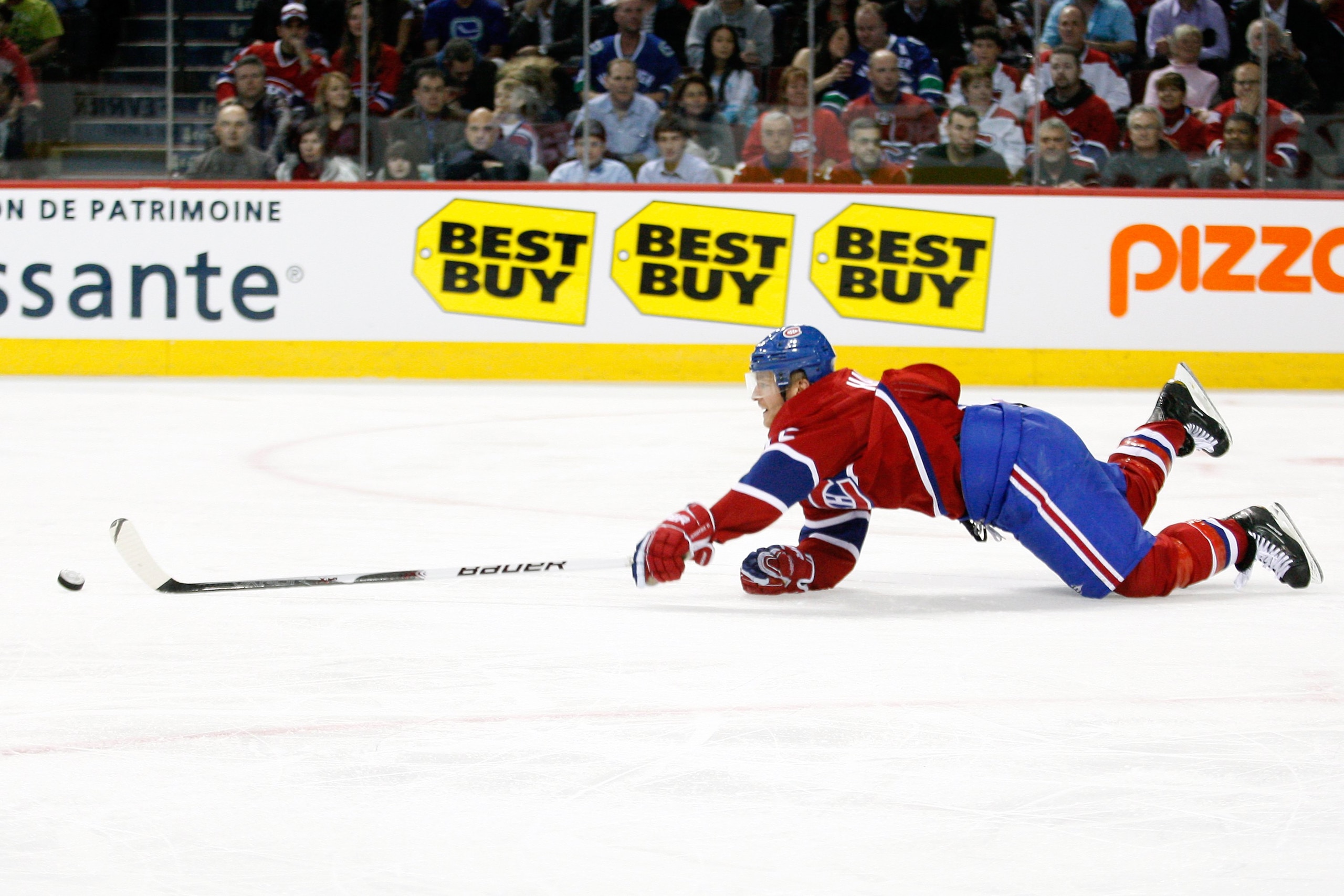 MONTREAL- NOVEMBER 9:  Jeff Halpern #15 of the Montreal Canadiens falls while skating with the puck during the NHL game against the Vancouver Canucks at the Bell Centre on November 9, 2010 in Montreal, Quebec, Canada.  The Canadiens defeated the Canucks 2