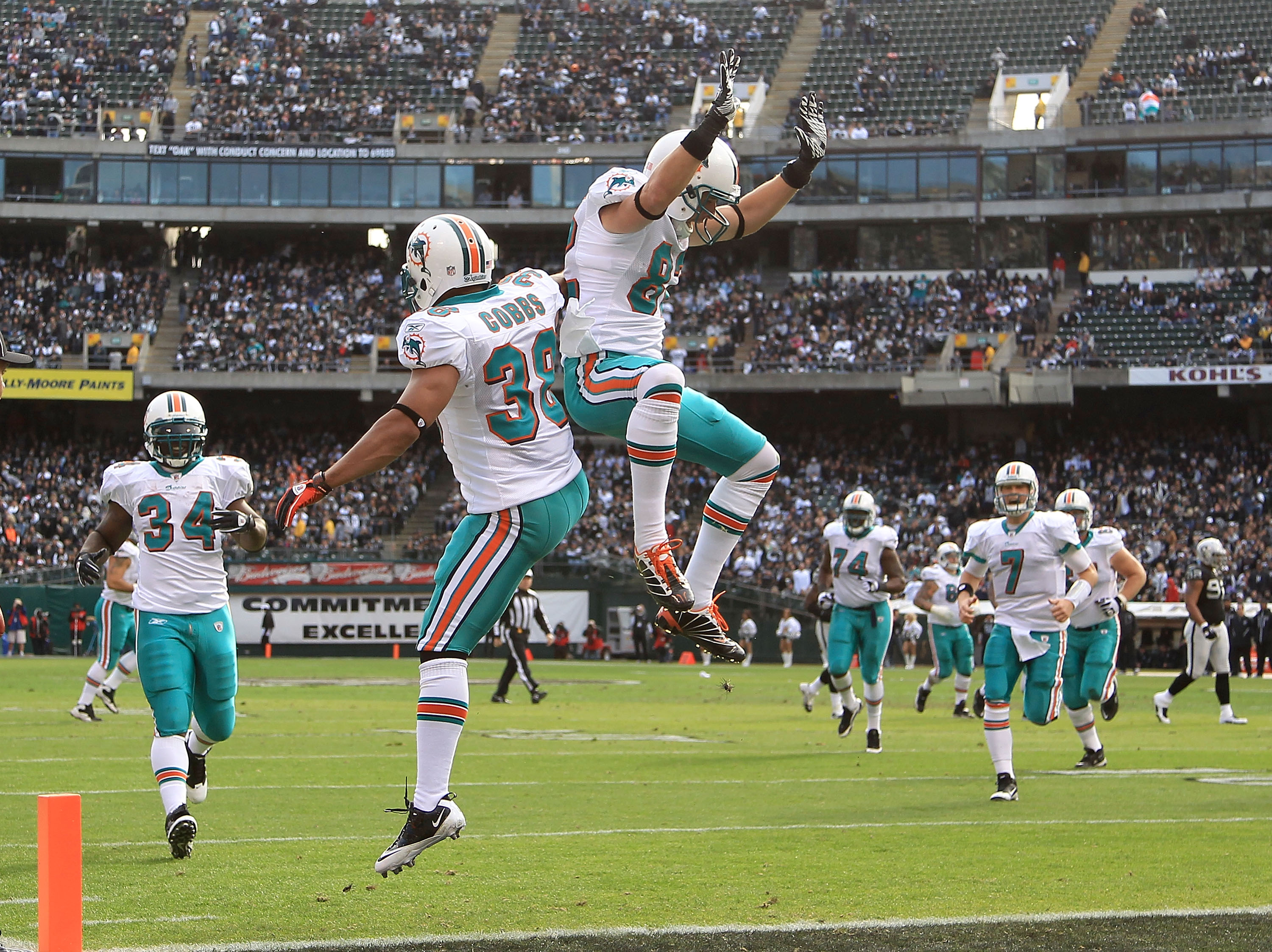 OAKLAND, CA - NOVEMBER 28:  Patrick Cobbs #38 and Brian Hartline #82 of the Miami Dolphins celebrate after Cobbs scored a touchdown against the Oakland Raiders at Oakland-Alameda County Coliseum on November 28, 2010 in Oakland, California.  (Photo by Ezra