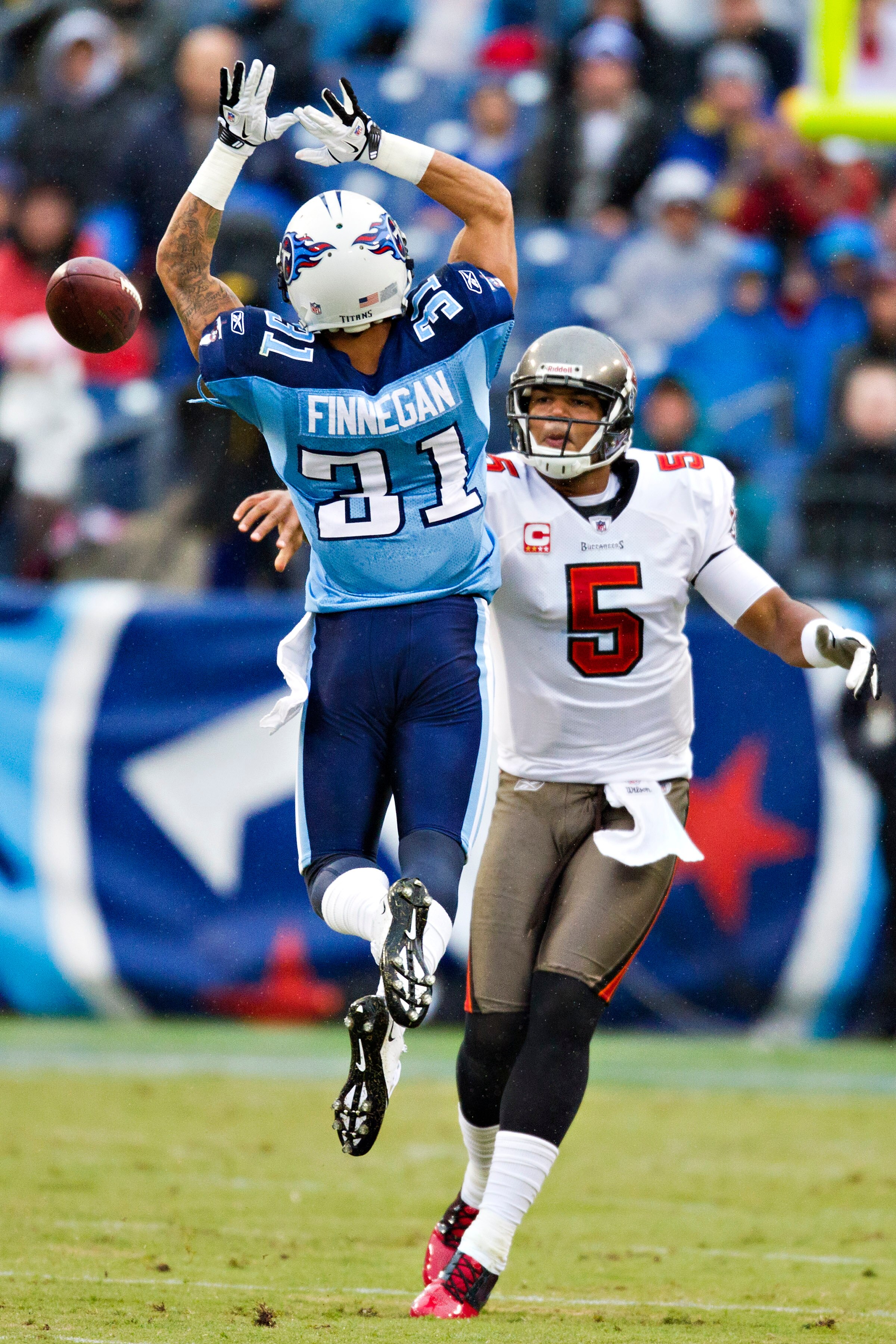 NASHVILLE, TN - NOVEMBER 27:   Quarterback Josh Freeman #5 of the Tampa Bay Buccaneers throws a pass around Cortland Finnegan #31 of the Tennessee Titans at LP Field on November 27, 2011 in Nashville, Tennessee.  (Photo by Wesley Hitt/Getty Images)