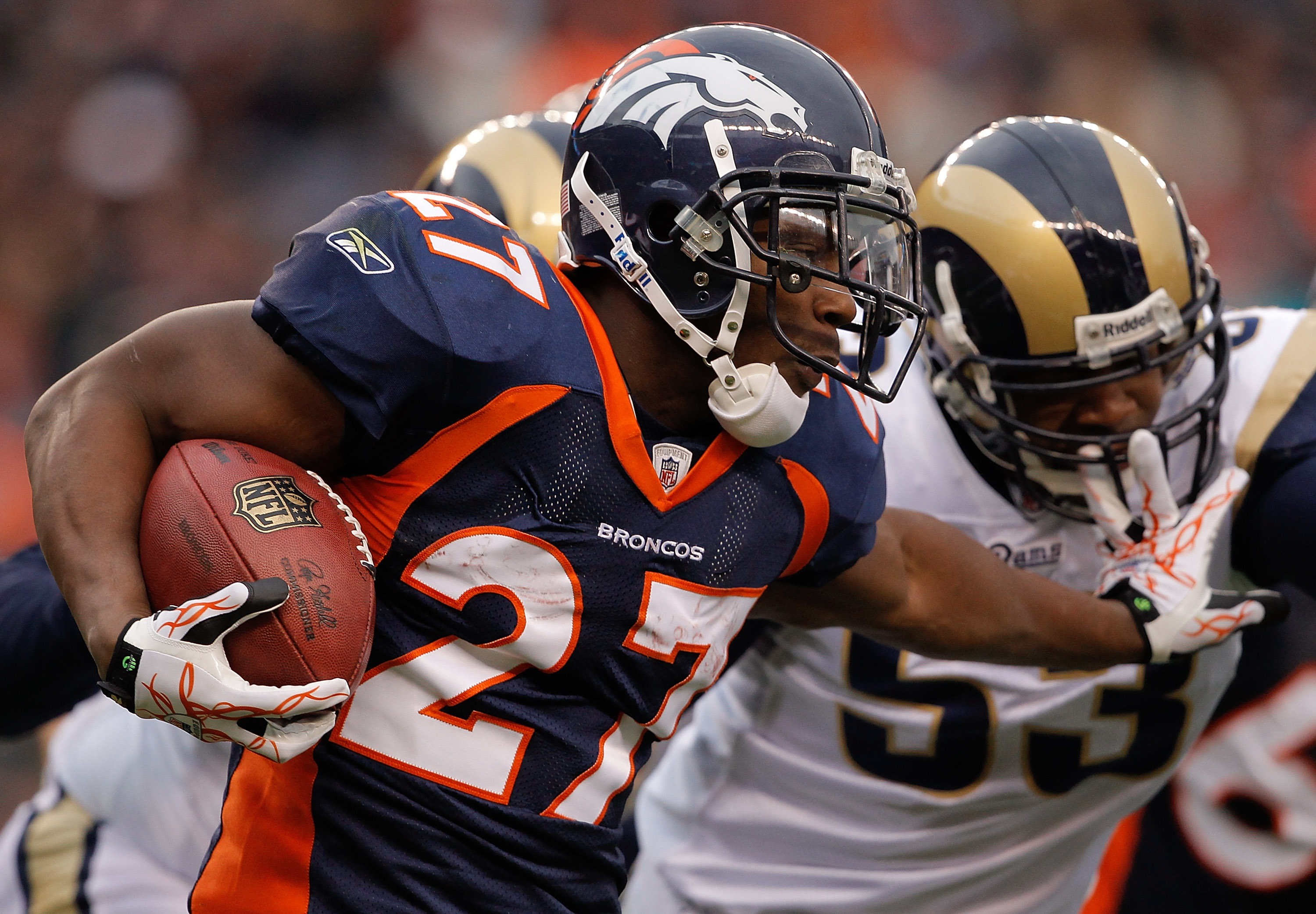 DENVER - NOVEMBER 28:  Running back Knowshon Moreno #27 of the Denver Broncos stiff-arms linebacker Na'il Diggs #53 of the St. Louis Rams in the first quarter at INVESCO Field at Mile High on November 28, 2010 in Denver, Colorado. (Photo by Justin Edmonds