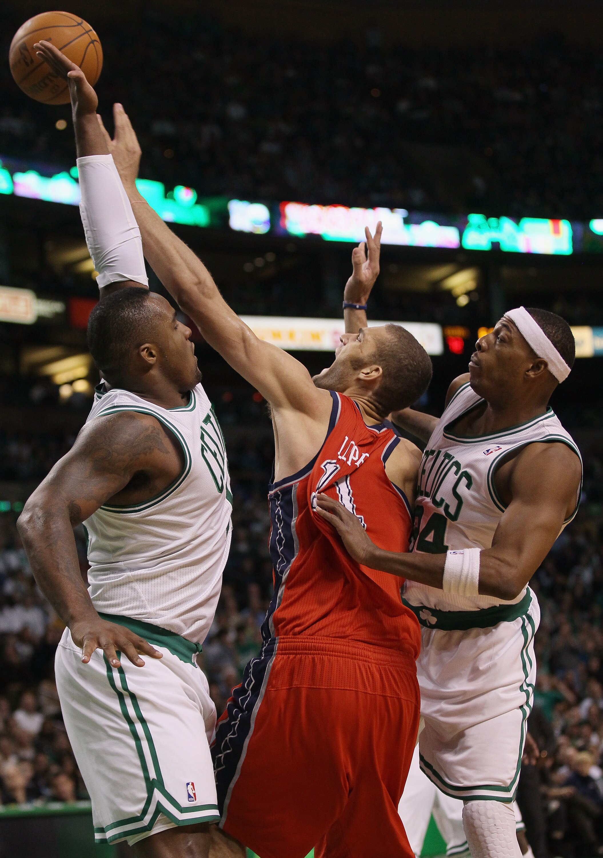 BOSTON - NOVEMBER 24:  Brook Lopez #11 of the New Jersey Nets takes a shot as Paul Pierce #34 and Glen Davis #11 of the Boston Celtics defend on November 24, 2010 at the TD Garden in Boston, Massachusetts. The Celtics defeated the nets 89-83. NOTE TO USER