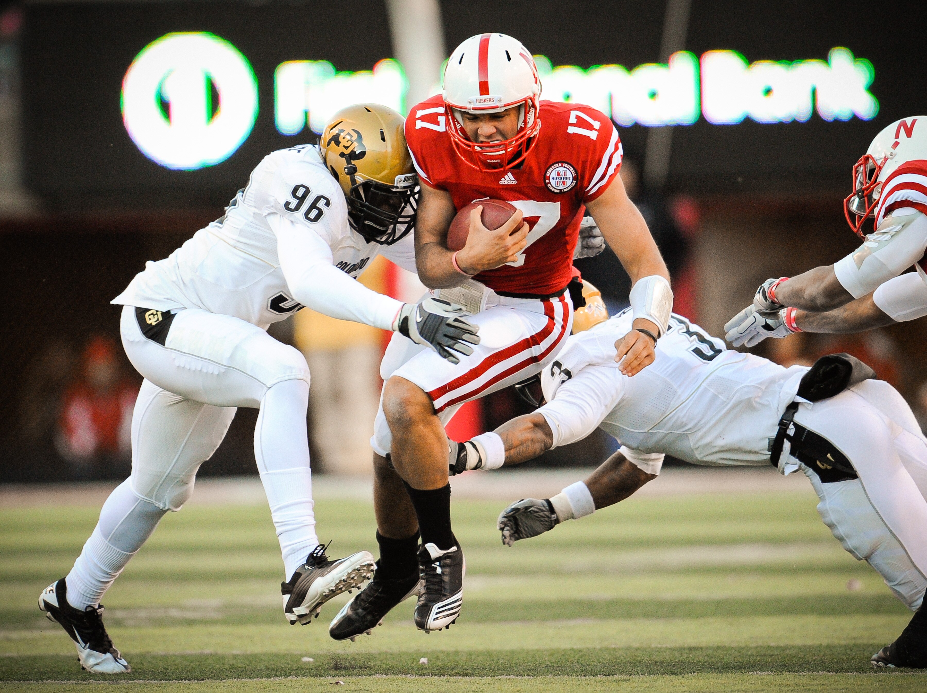 LINCOLN, NE - NOVEMBER 26: Cody Green #17 of the Nebraska Cornhuskers takes a hit from Chidera Uzo-Diribe #96 and Jimmy Smith #3 of the Colorado Buffaloes during the first half of their game at Memorial Stadium on November 26, 2010 in Lincoln, Nebraska.