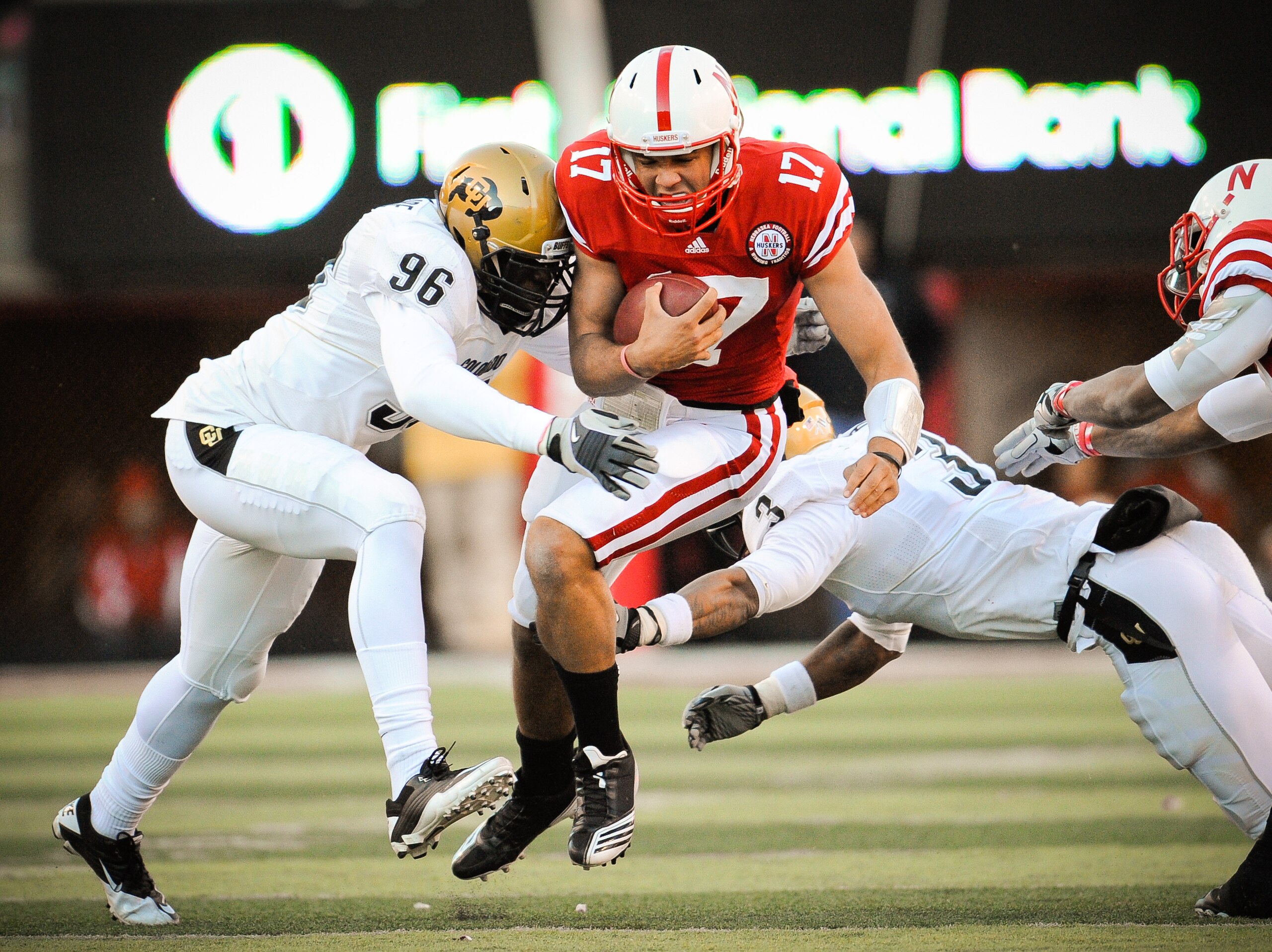 LINCOLN, NE - NOVEMBER 26: Cody Green #17 of the Nebraska Cornhuskers takes a hit from Chidera Uzo-Diribe #96 and Jimmy Smith #3 of the Colorado Buffaloes during the first half of their game at Memorial Stadium on November 26, 2010 in Lincoln, Nebraska.