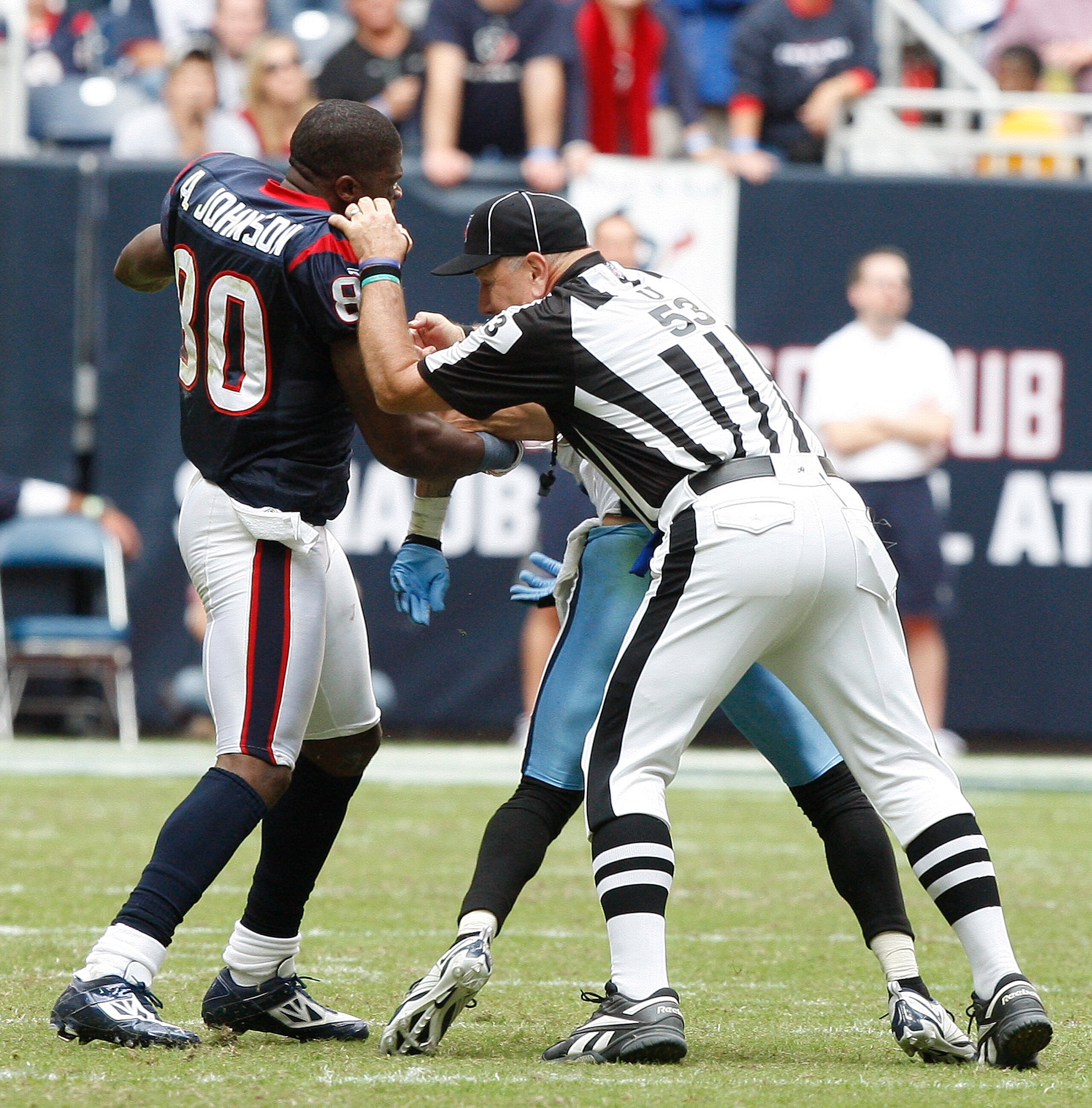 HOUSTON - NOVEMBER 28: Wide receiver Andre Johnson #80 of the Houston Texans is separated by umpire Garth DeFerlice #53 from cornerback Cortland Finnegan #31 of the Tennessee Titans after the two exchanged punches in the fourth quarter at Reliant Stadium HOUSTON - NOVEMBER 28: Wide receiver Andre Johnson #80 of the Houston Texans is separated by umpire Garth DeFerlice #53 from cornerback Cortland Finnegan #31 of the Tennessee Titans after the two exchanged punches in the fourth quarter at Reliant Stadium