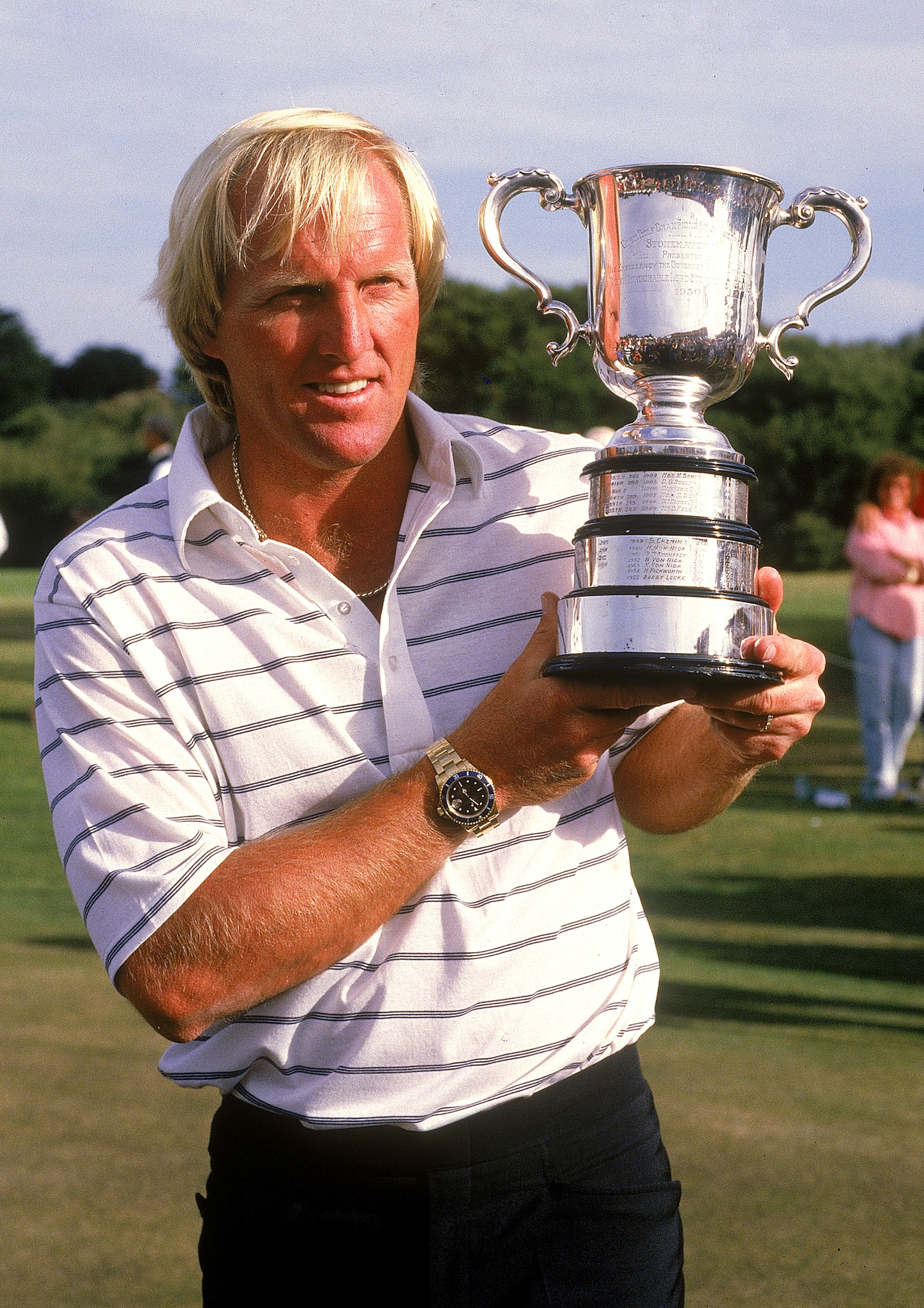 MELBOURNE, AUSTRALIA - 1988:  Greg Norman of Australia holds aloft the winners trophy after winning the Golf Championships 1988 in Melbourne, Australia. Norman is a professional golfer and entrepreneur who spent 331 weeks as the world's number one ranked