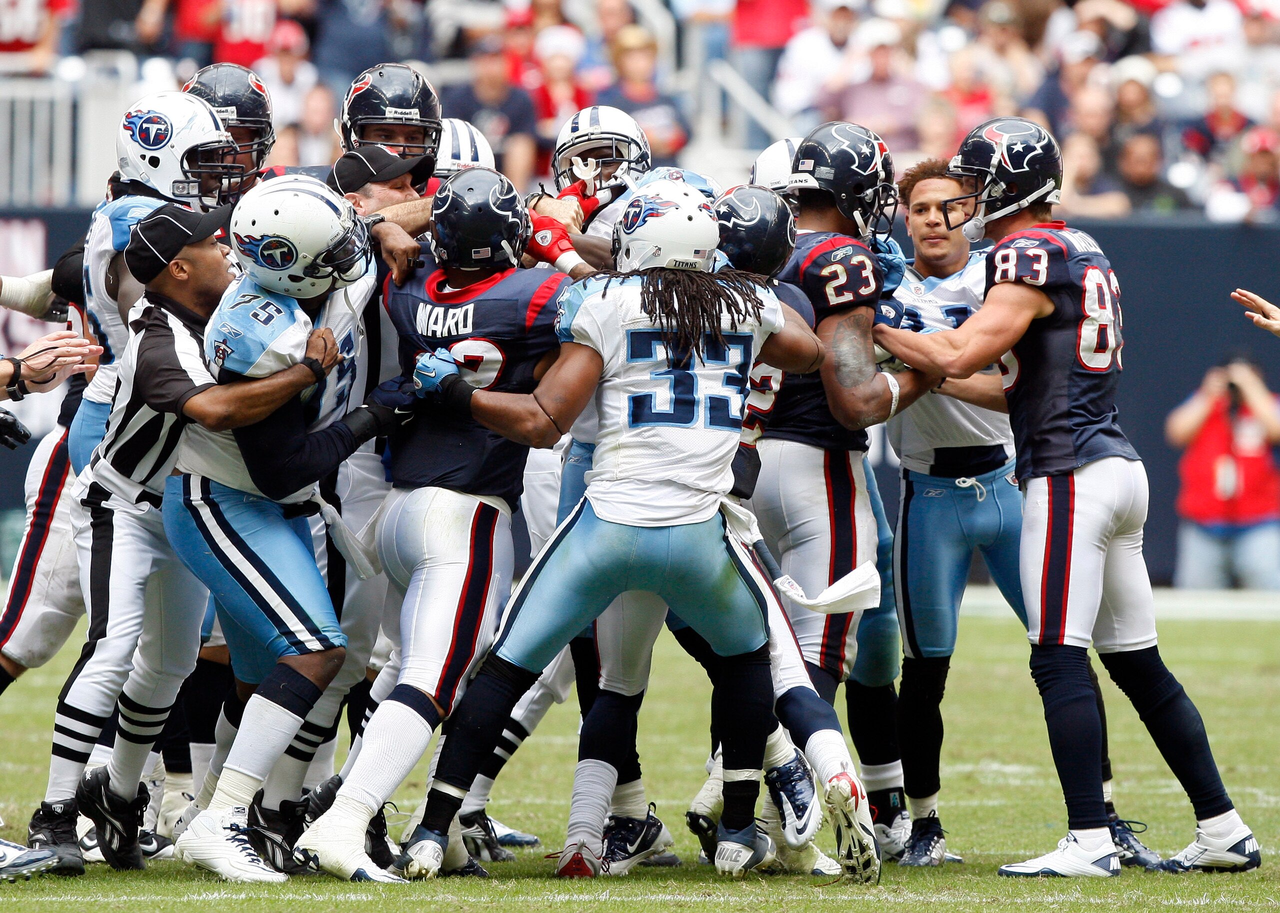 HOUSTON - NOVEMBER 28: Officials attempt to separate players from both the Houston Texans and Tennessee Titans after a bench emptying brawl in the fourth quarter that was started by Andre Johnson of the Houston Texans and Cortland Finnegan of the Tenness HOUSTON - NOVEMBER 28: Officials attempt to separate players from both the Houston Texans and Tennessee Titans after a bench emptying brawl in the fourth quarter that was started by Andre Johnson of the Houston Texans and Cortland Finnegan of the Tenness