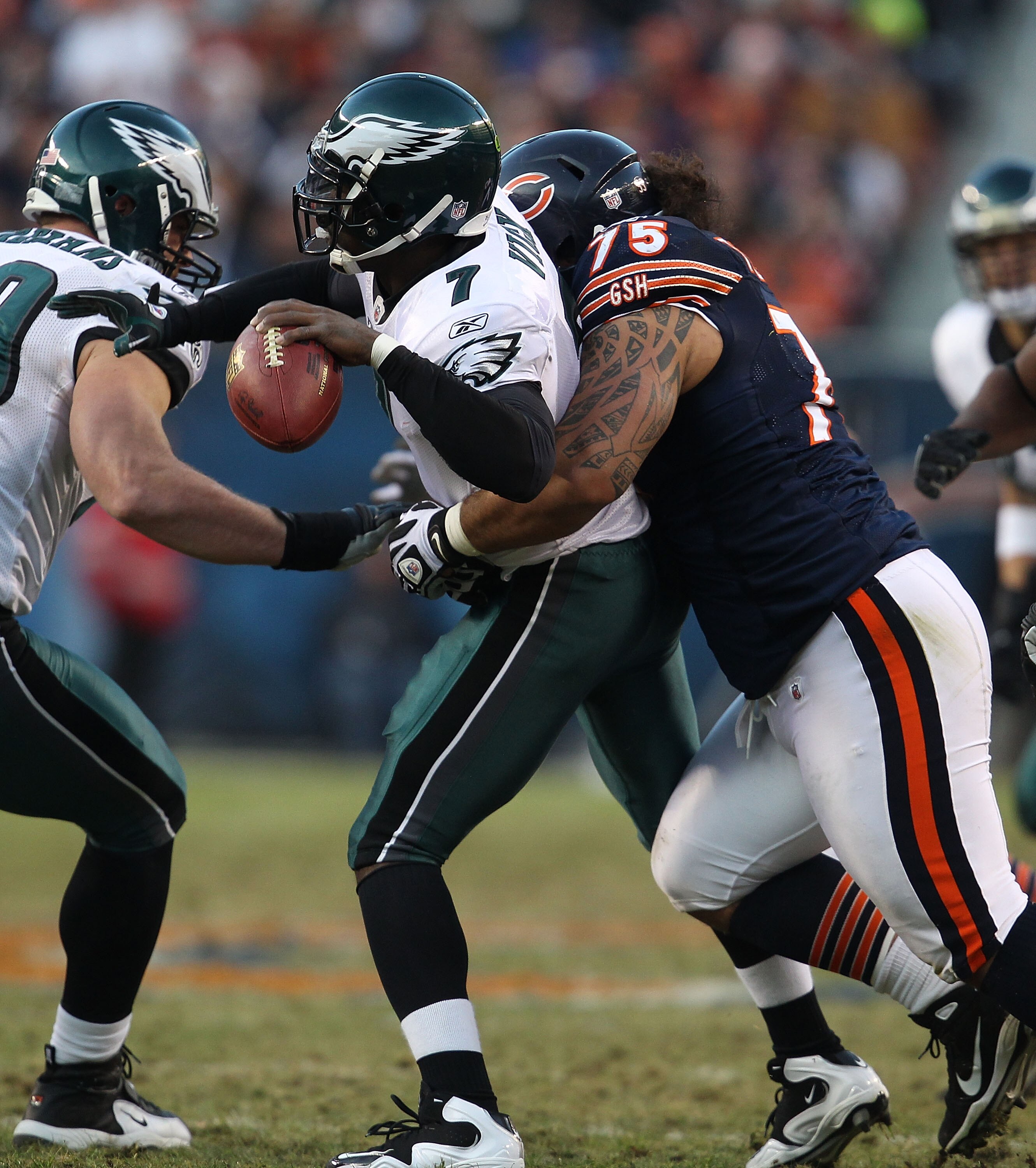 CHICAGO - NOVEMBER 28: Michael Vick #7 of the Philadelphia Eagles is wrapped up trying to pass by Matt Toeaina #75 of the Chicago Bears at Soldier Field on November 28, 2010 in Chicago, Illinois.  (Photo by Jonathan Daniel/Getty Images)