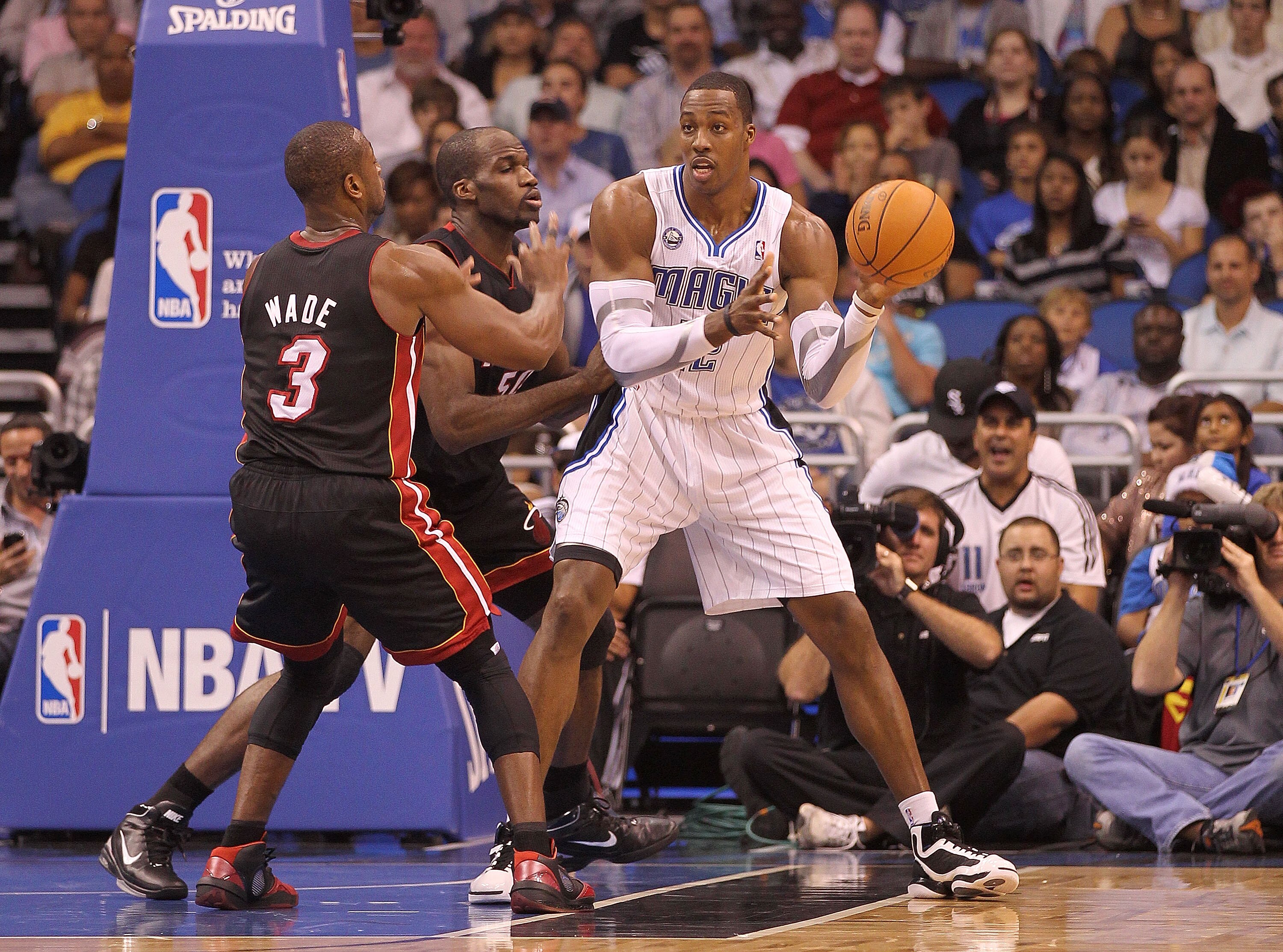 ORLANDO, FL - NOVEMBER 24:  Dwight Howard #12 of the Orlando Magic passes over Dwyane Wade #3 of the Miami Heat during a game at Amway Arena on November 24, 2010 in Orlando, Florida. NOTE TO USER: User expressly acknowledges and agrees that, by downloadin
