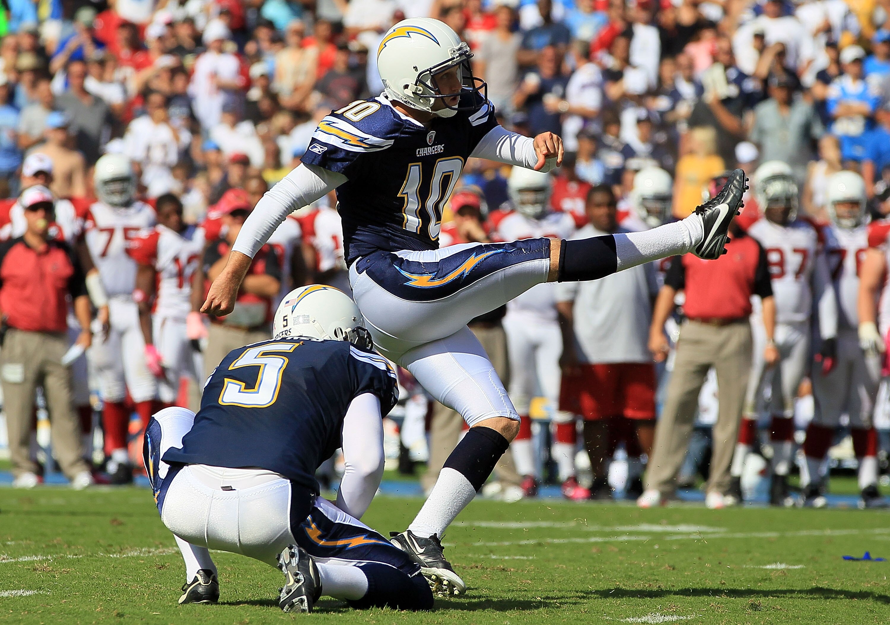 SAN DIEGO - OCTOBER 03:  Nate Kaeding #10 of the San Diego Chargers kicks the ball from Mike Scifres #5 during the game against the Arizona Cardinals at Qualcomm Stadium on October 3, 2010 in San Diego, California.  (Photo by Jeff Gross/Getty Images)