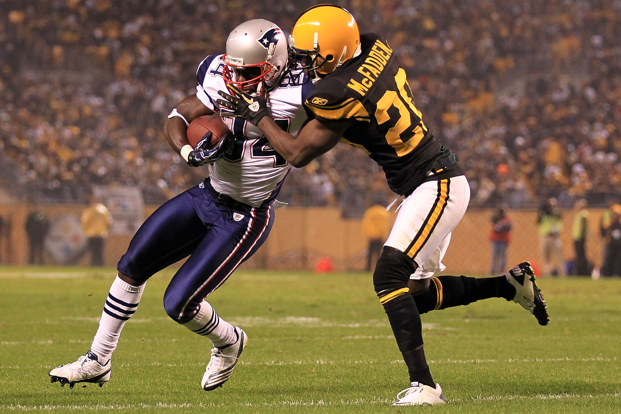 PITTSBURGH - NOVEMBER 14:  Deion Branch #84 of the New England Patriots is tackled Bryant McFadden #20 of the Pittsburgh Steelers on November 14, 2010 at Heinz Field in Pittsburgh, Pennsylvania.  (Photo by Chris McGrath/Getty Images)
