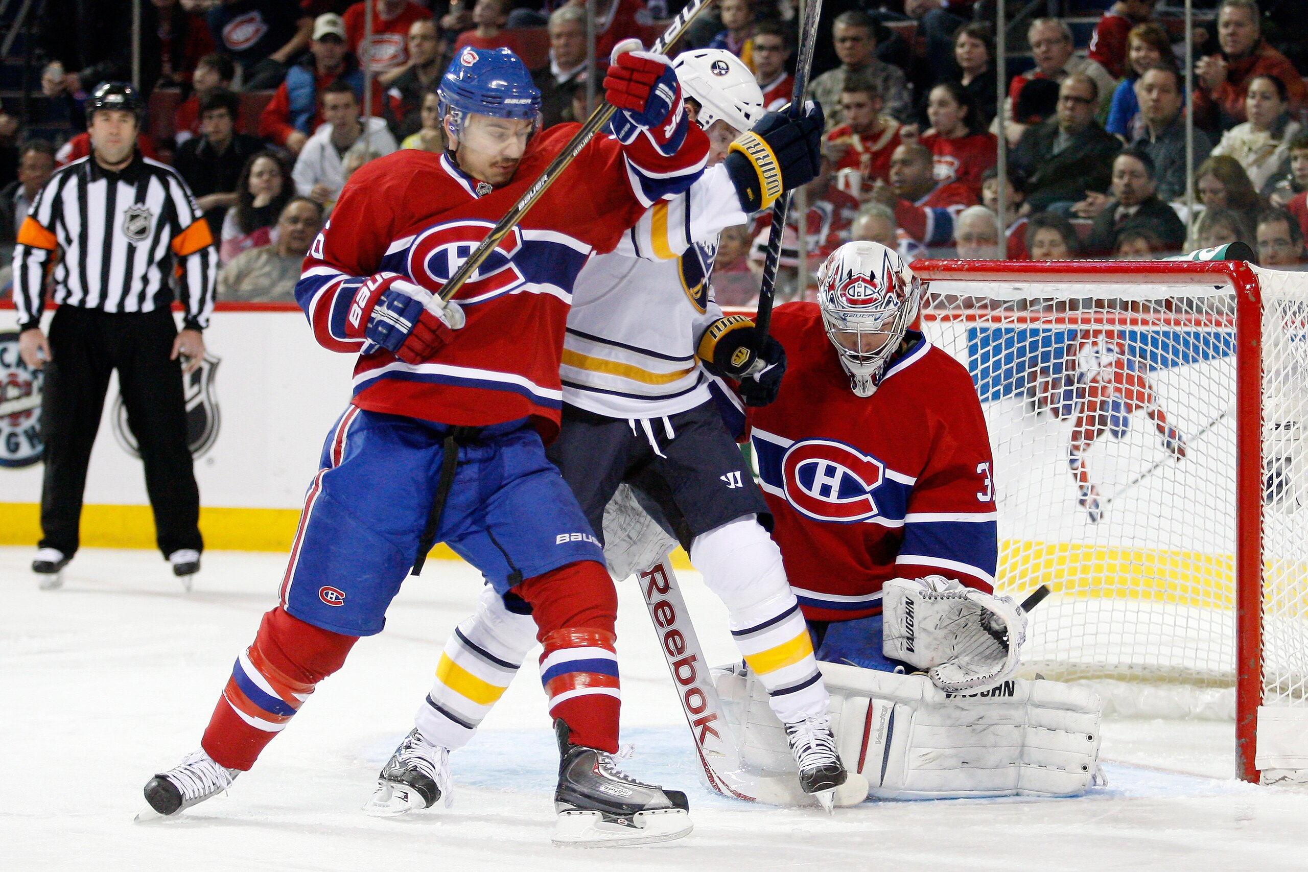 MONTREAL- NOVEMBER 27:  Carey Price #31 of the Montreal Canadiens stops the puck in front of teammate Josh Gorges #26 and Thomas Vanek #26 of the Buffalo Sabres during the NHL game at the Bell Centre on November 27, 2010 in Montreal, Quebec, Canada.  (Pho