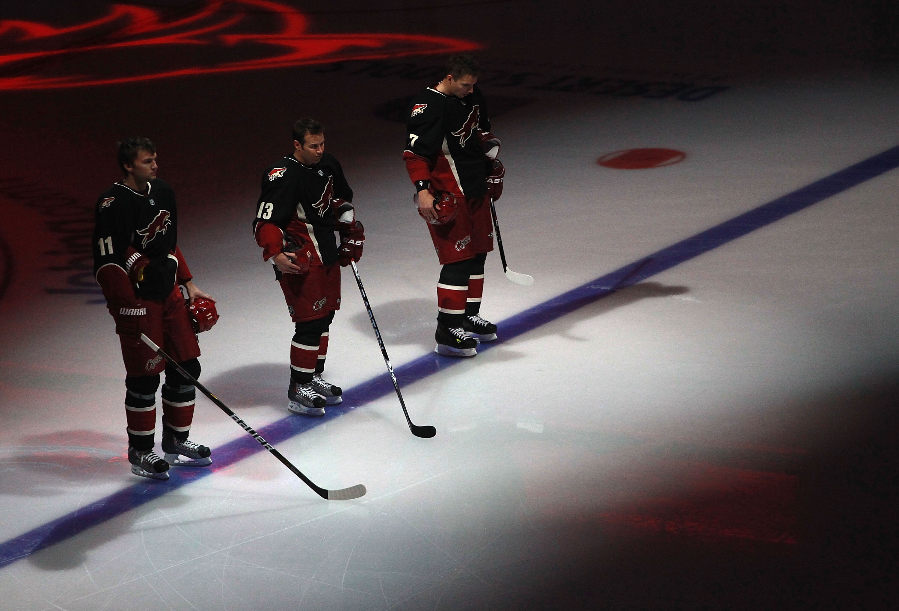 GLENDALE, AZ - NOVEMBER 23:  (L-R) Martin Hanzal #11, Ray Whitney #13 and Radim Vrbata #17 of the Phoenix Coyotes stand attended for the National Anthem before the NHL game against the Edmonton Oilers at Jobing.com Arena on November 23, 2010 in Glendale,