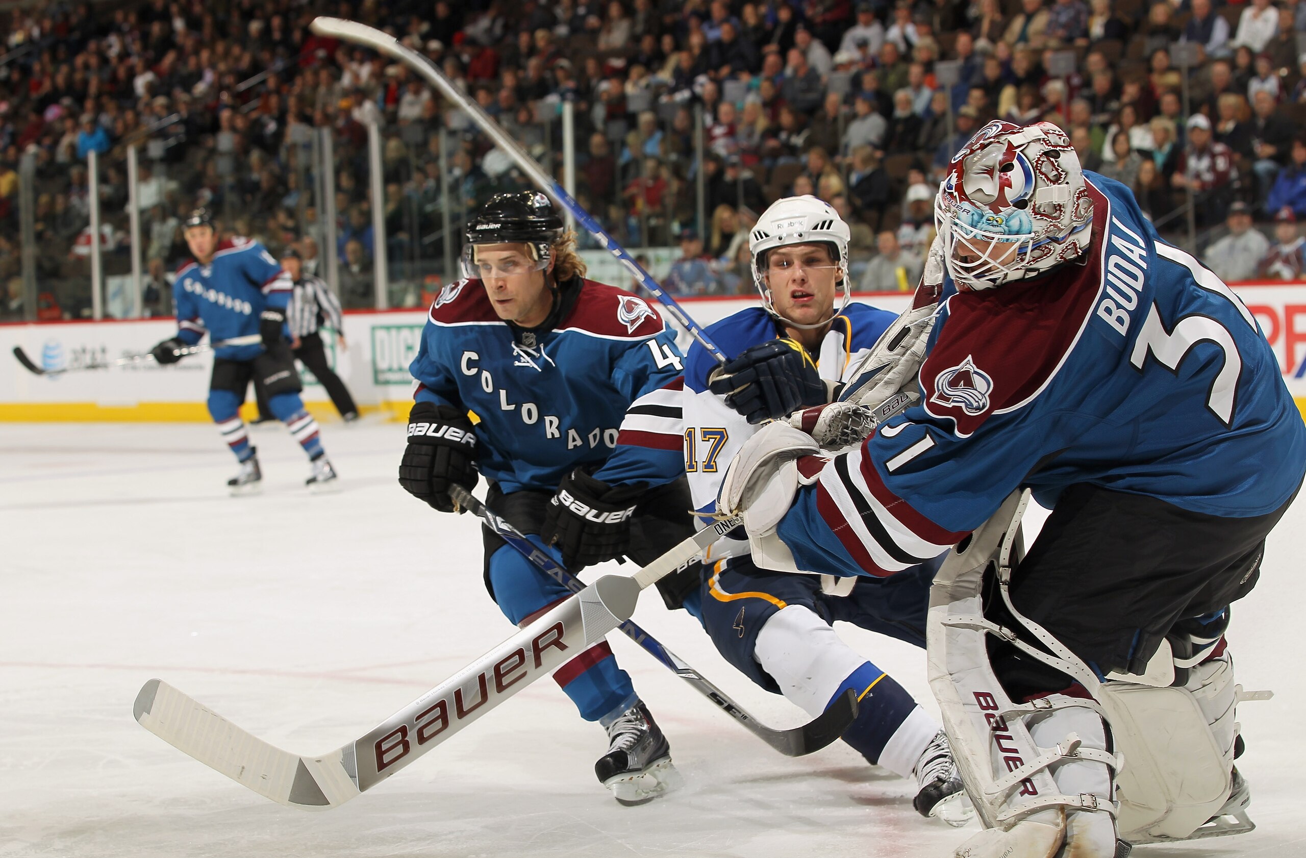 DENVER - NOVEMBER 15:  Goalie Peter Budaj #31 of the Colorado Avalanche clears the puck as John-Michael Liles #4 defends against Vladimir Sobotka #17 of the St. Louis Blues at the Pepsi Center on November 15, 2010 in Denver, Colorado. The Avalanche defeat