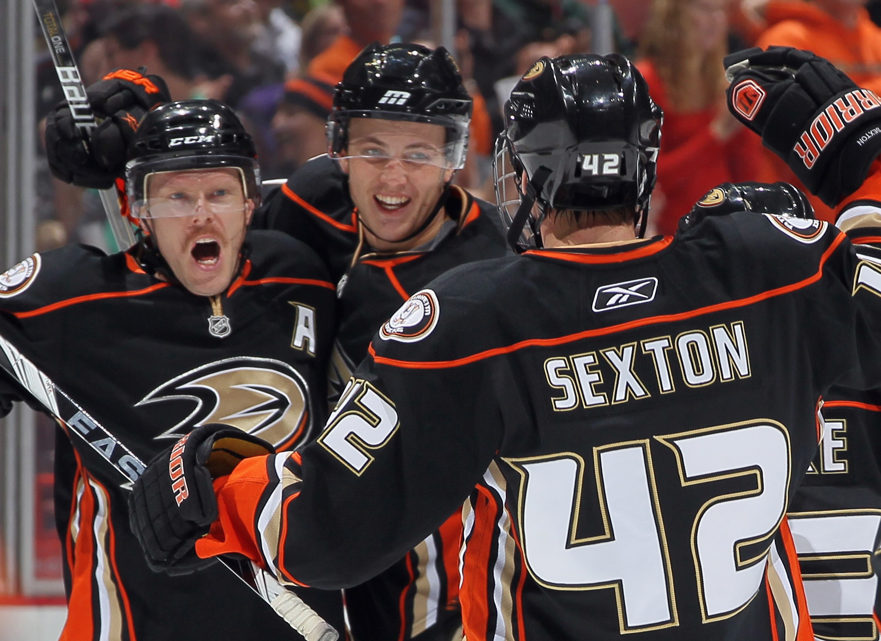 ANAHEIM, CA - NOVEMBER 26:  (L-R) Saku Koivu #11, Cam Fowler #4 and Dan Sexton #42 of the Anaheim Ducks celebrate Sexton's first period goal against the Chicago Blackhawks at the Honda Center on November 26, 2010 in Anaheim, California.  (Photo by Jeff Gr