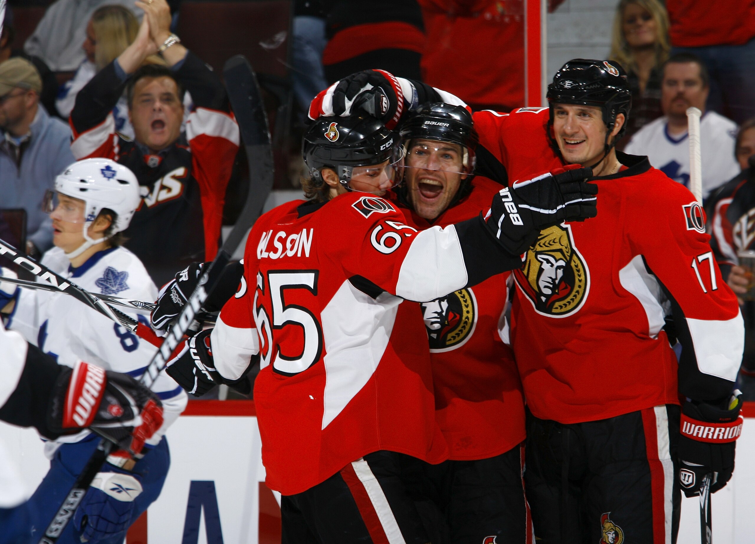 OTTAWA, ON - NOVEMBER 27:  Mike Fisher #12 of the Ottawa Senators celebrates his goal with teammates Erik Karlsson #65 and Filip Kuba #17 while Mikhail Grabovski #84 of the Toronto Maple Leafs skates away dejectedly during a game at Scotiabank Place on No