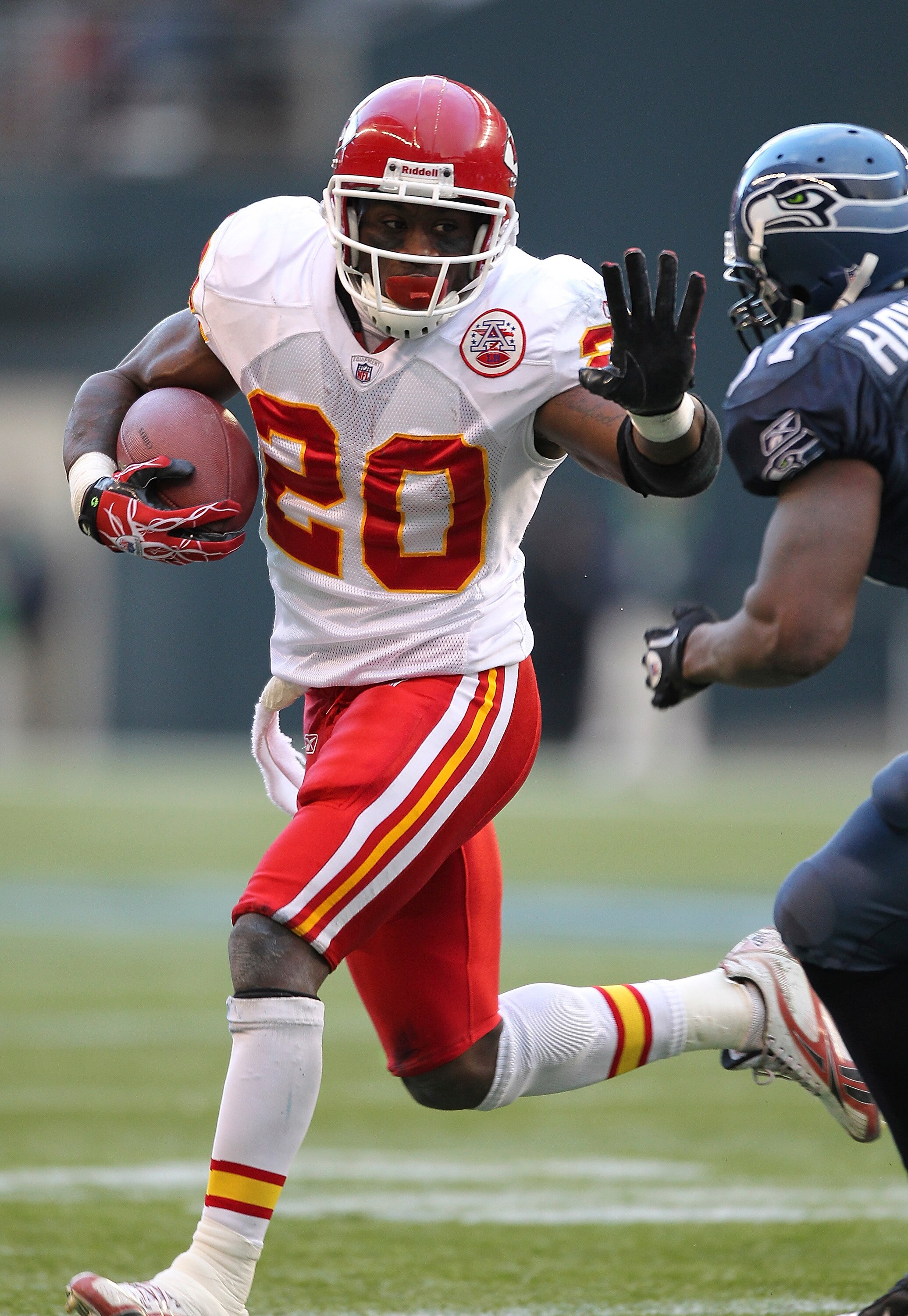 SEATTLE - NOVEMBER 28:  Running back Thomas Jones #20 of the Kansas City Chiefs rushes against David Hawthorne #57 of the Seattle Seahawks at Qwest Field on November 28, 2010 in Seattle, Washington. The Chiefs defeated the Seahawks 42-24. (Photo by Otto G