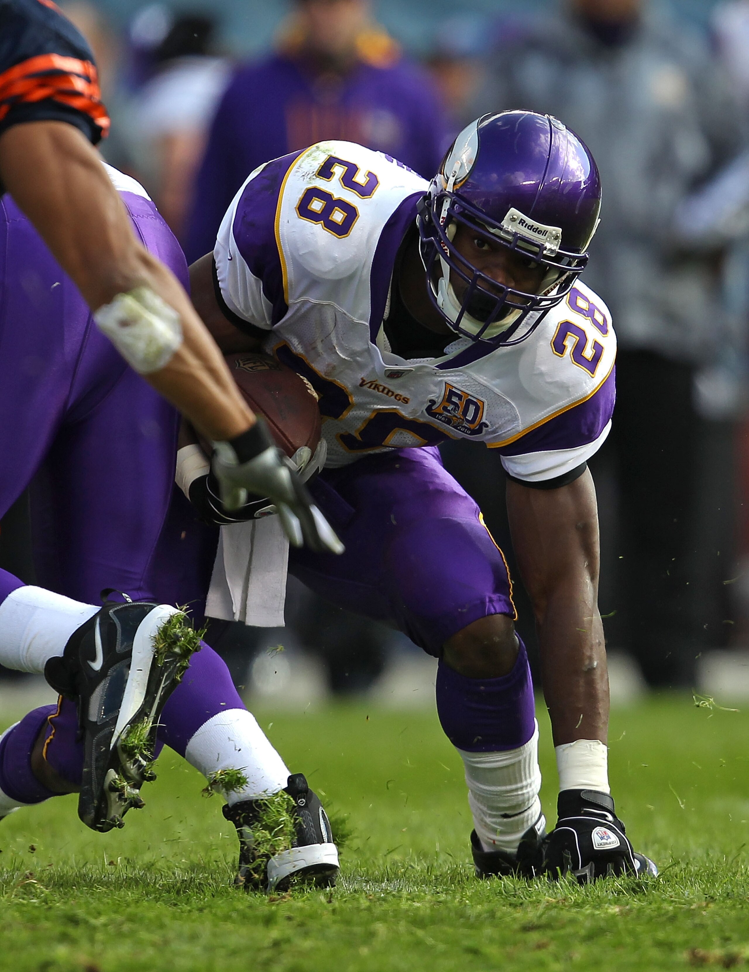 CHICAGO - NOVEMBER 14: Adrian Peterson #28 of the Minnesota Vikings tries to keep his balance as he runs against the Chicago Bears at Soldier Field on November 14, 2010 in Chicago, Illinois. The Bears defeated the Vikings 27-13. (Photo by Jonathan Daniel/
