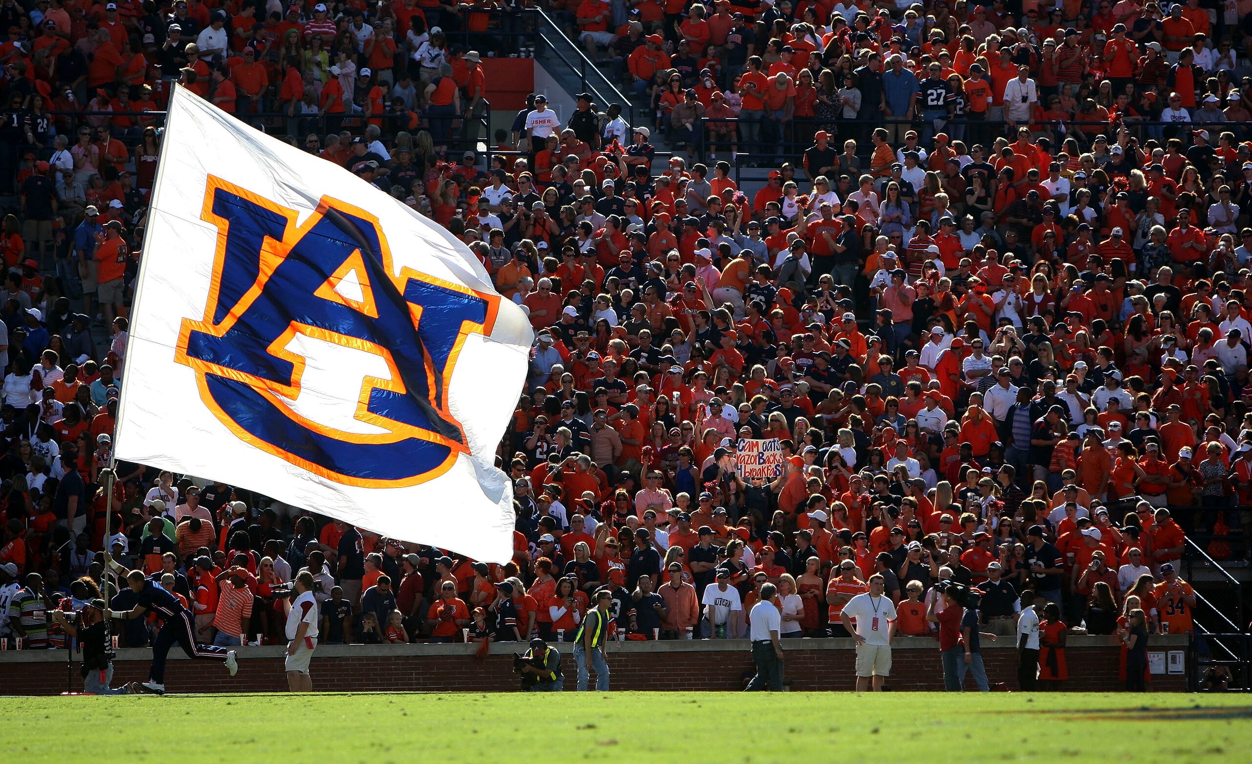 AUBURN - OCTOBER 16:  An Auburn cheerleader runs in the end zone with the Auburn flag after a touchdown during the game between the Arkansas Razorbacks and the Auburn Tigers at Jordan-Hare Stadium on October 16, 2010 in Auburn, Alabama.  (Photo by Mike Za