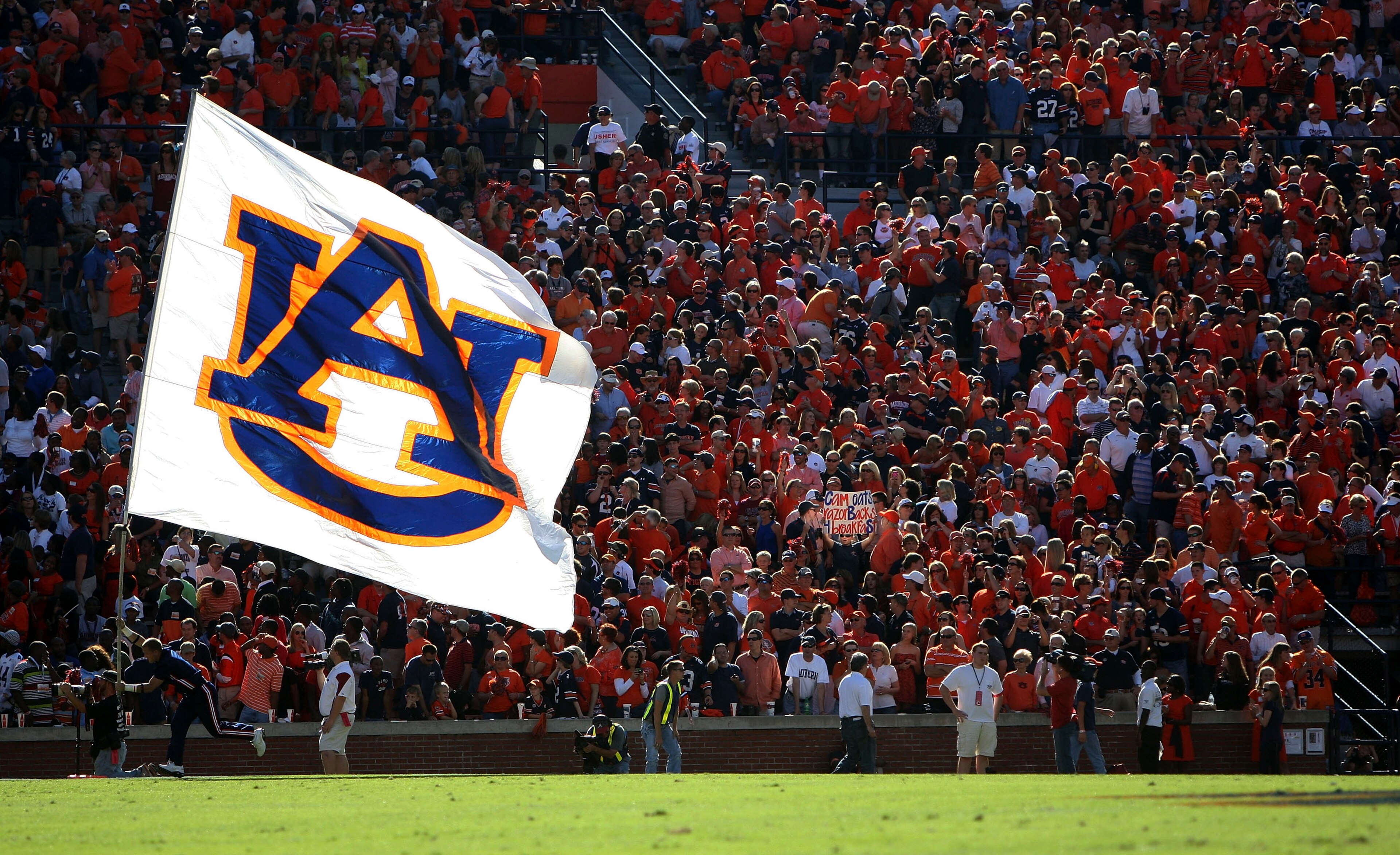 AUBURN - OCTOBER 16:  An Auburn cheerleader runs in the end zone with the Auburn flag after a touchdown during the game between the Arkansas Razorbacks and the Auburn Tigers at Jordan-Hare Stadium on October 16, 2010 in Auburn, Alabama.  (Photo by Mike Za