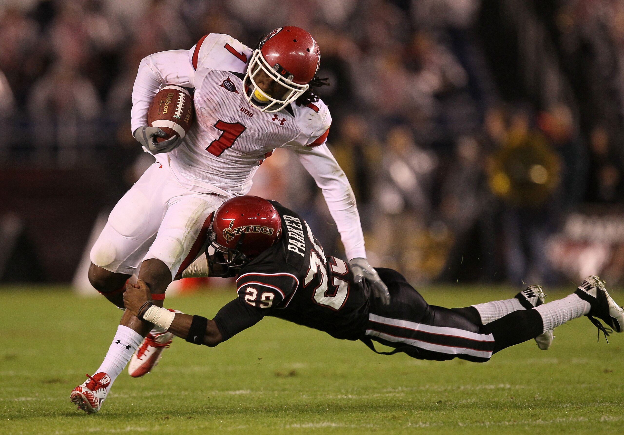 SAN DIEGO - NOVEMBER 20:  Wide receiver Shaky Smithson #1 of the Utah Utes is tackled by defensive back Larry Parker #29 of the San Diego State Aztecs at Qualcomm Stadium on November 20, 2010 in San Diego, California. Utah won 38-34.  (Photo by Stephen Du